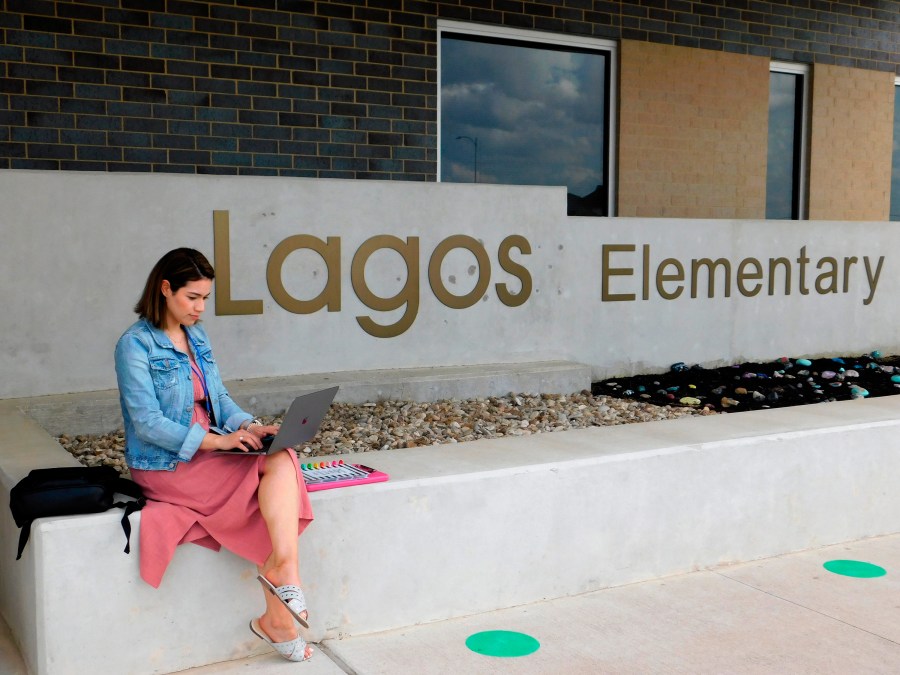 First-year teacher Cindy Hipps sits outside of Lagos Elementary School, at Manor Independent School District campus east of Austin, Texas where she has taught first grade in a virtual and in-person hybrid classroom during the COVID-19 pandemic. (Acacia Coronado/Report for America via AP)