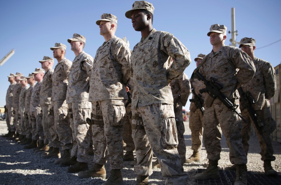 In this Jan. 15, 2018, file photo, U.S. Marines watch during the change of command ceremony at Task Force Southwest military field in Shorab military camp of Helmand province, Afghanistan.(AP Photo/Massoud Hossaini, File)