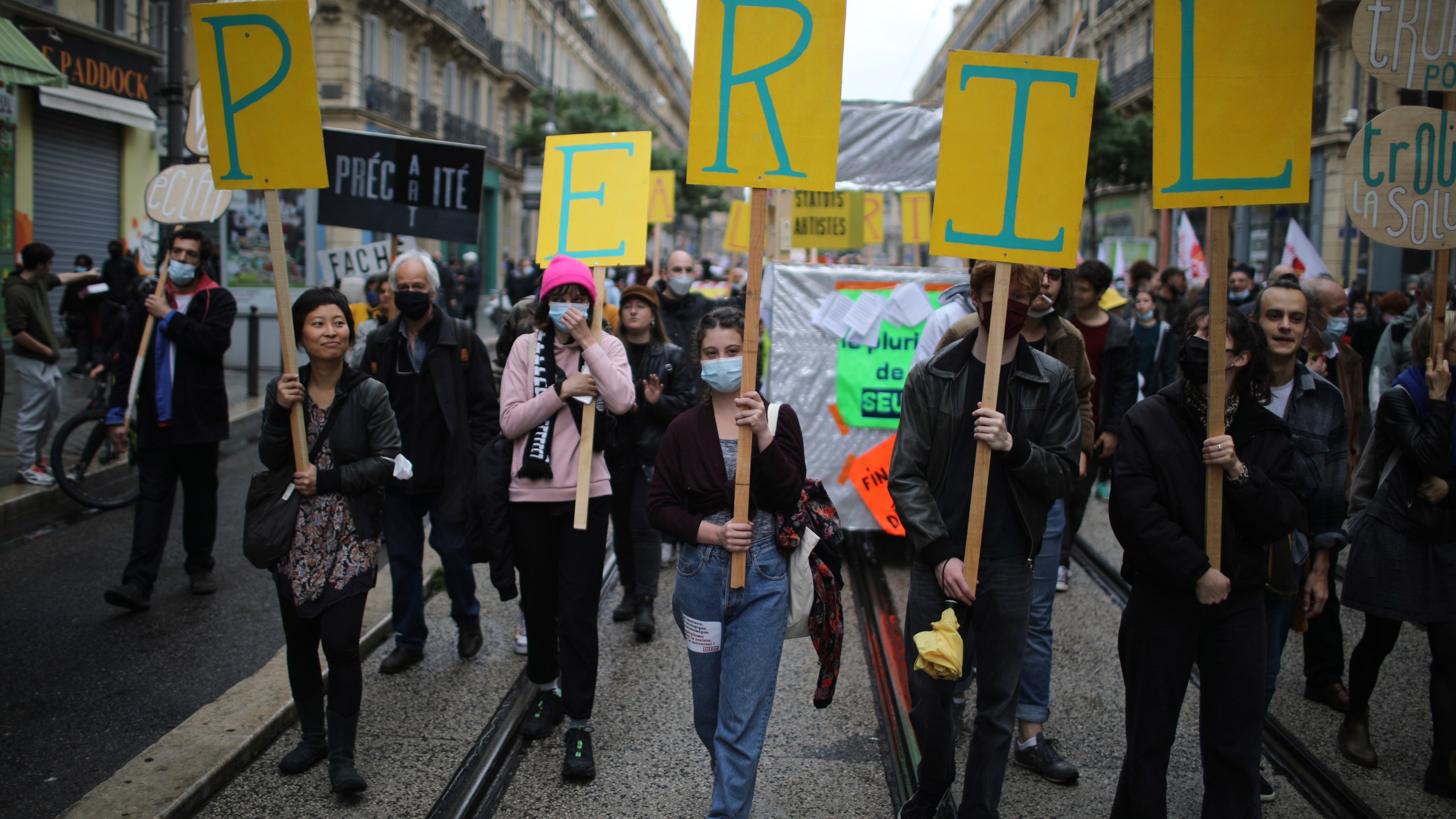 Workers demonstrate with placards reading "Peril" on May Day in Marseille, southern France, Saturday, May 1, 2021. (AP Photo/Daniel Cole)