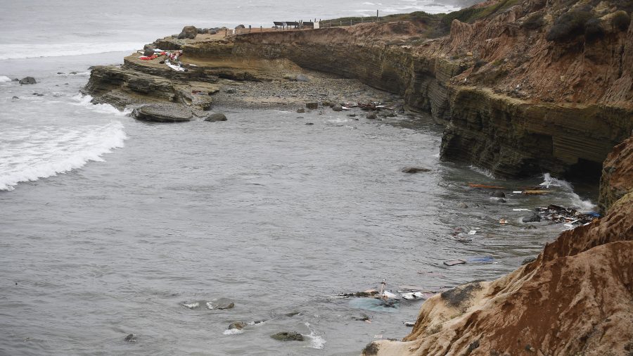 Wreckage and debris from a capsized boat washes ashore at Cabrillo National Monument near where a boat capsized just off the San Diego coast on May 2, 2021. (Denis Poroy / Associated Press)