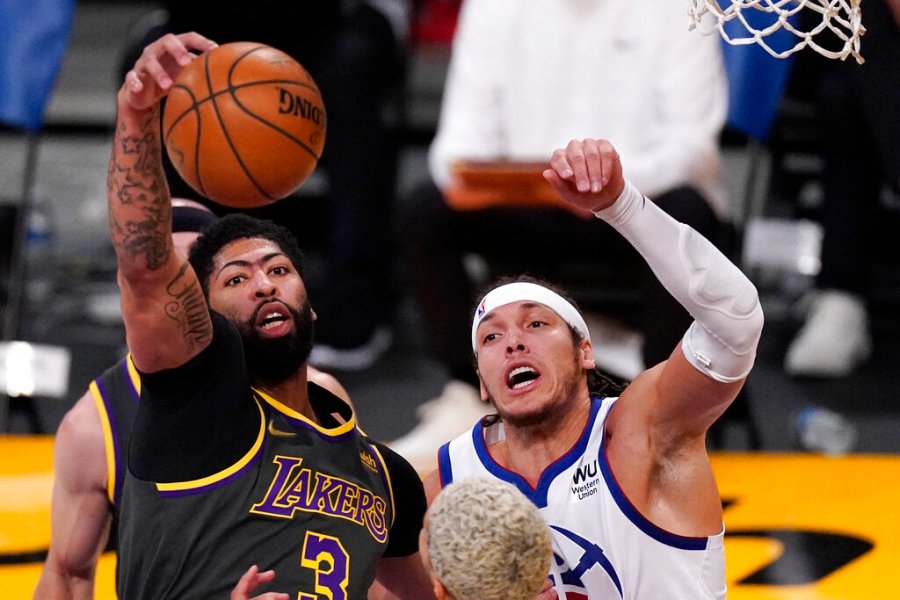 Los Angeles Lakers forward Anthony Davis, left, grabs a rebound away from Denver Nuggets forward Aaron Gordon during the first half of an NBA basketball game Monday, May 3, 2021, in Los Angeles. (AP Photo/Mark J. Terrill)