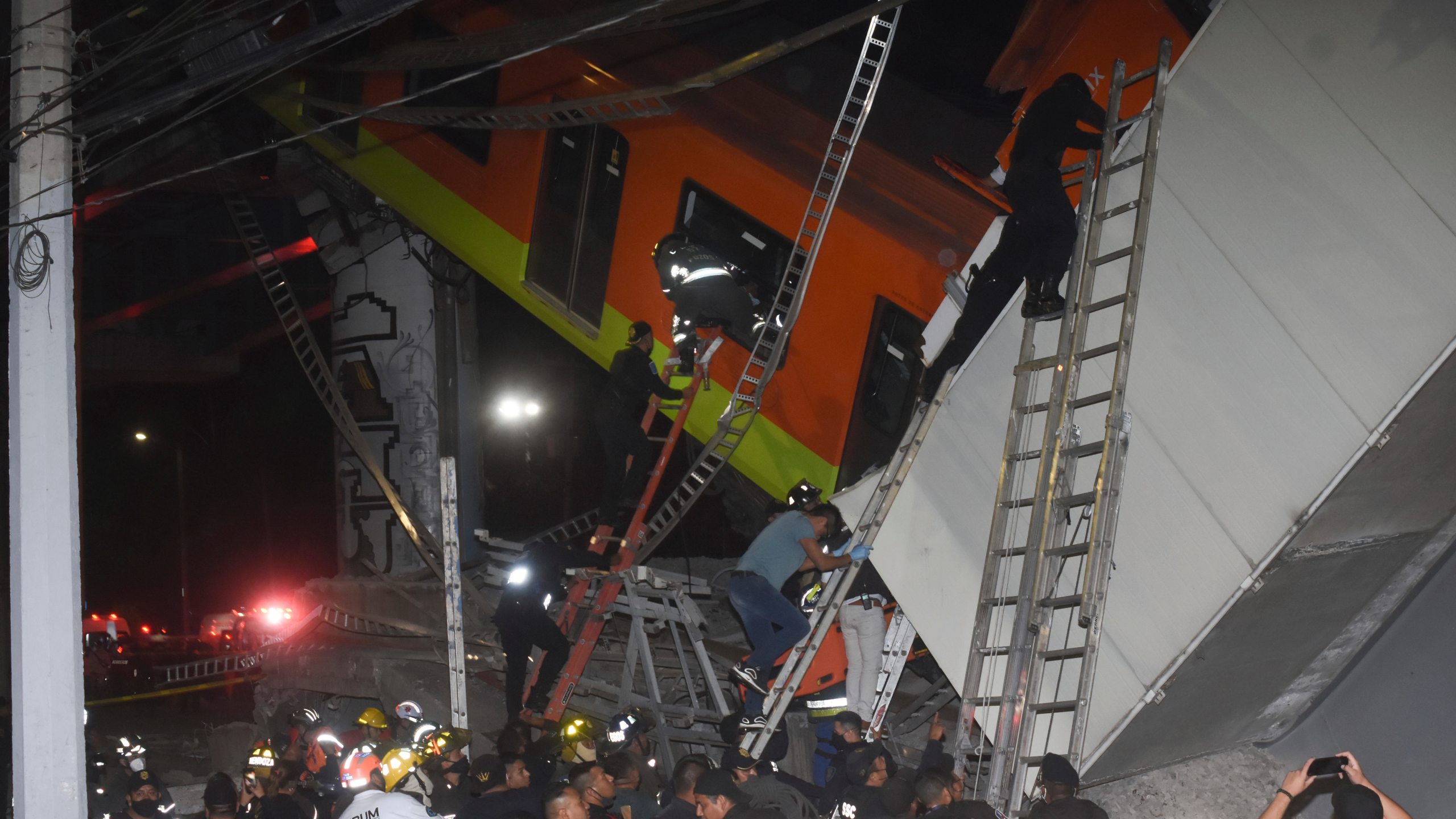 Mexico City firefighters and rescue personnel work to recover victims from a subway car that fell after a section of Line 12 of the subway collapsed in Mexico City on May 3, 2021. (Jose Ruiz/Associated Press)