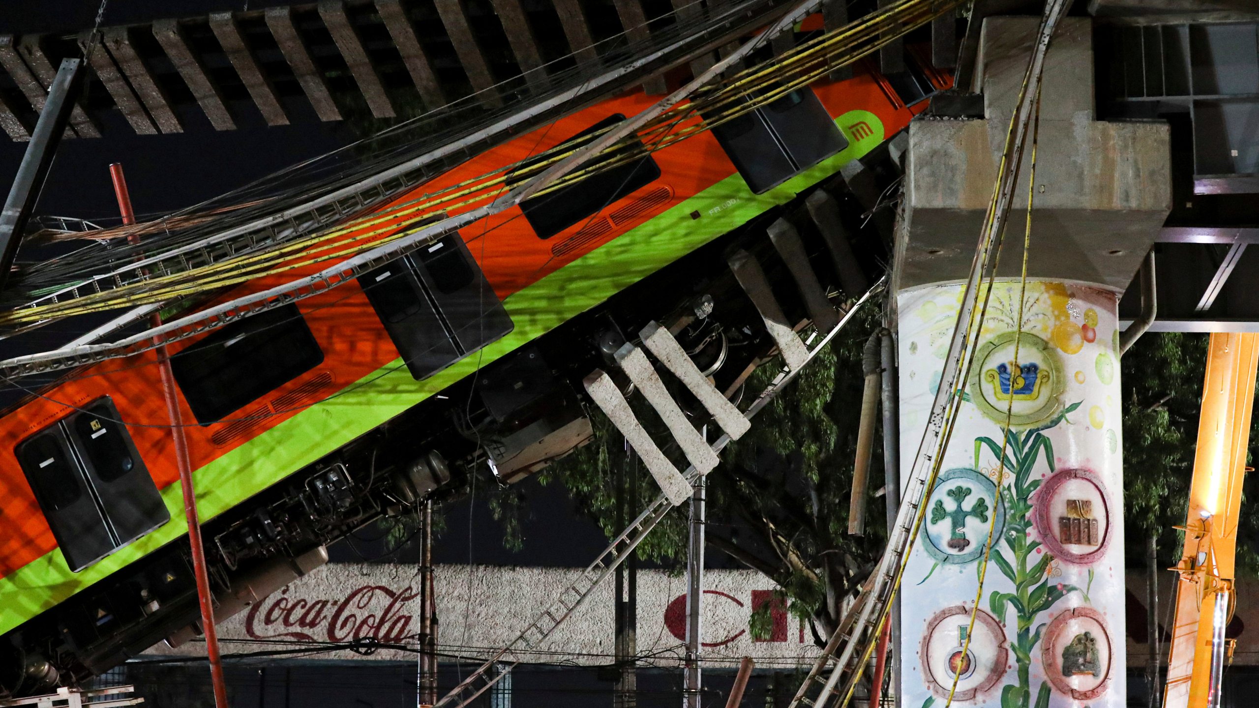 Mexico City's subway cars lay at an angle after a section of Line 12 of the subway collapsed in Mexico City on May 4, 2021. (Marco Ugarte / Associated Press)