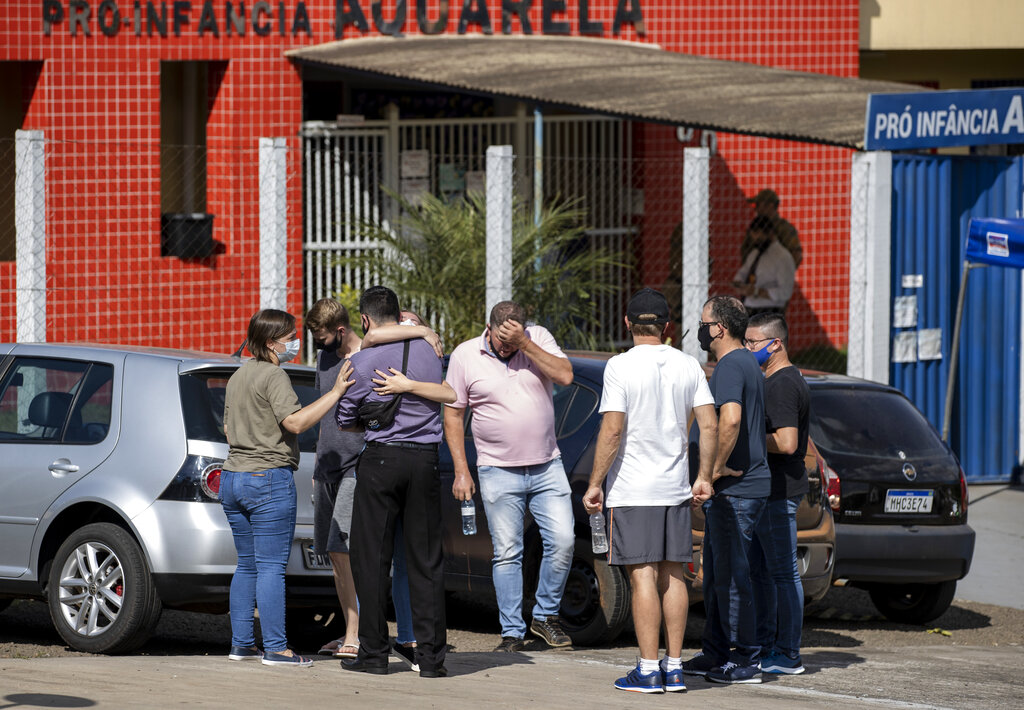 Relatives gather outside the Aquarela preschool in Saudades, in the southern state of Santa Catarina, Brazil, Tuesday, May 4, 2021. (AP Photo/Liamara Polli)