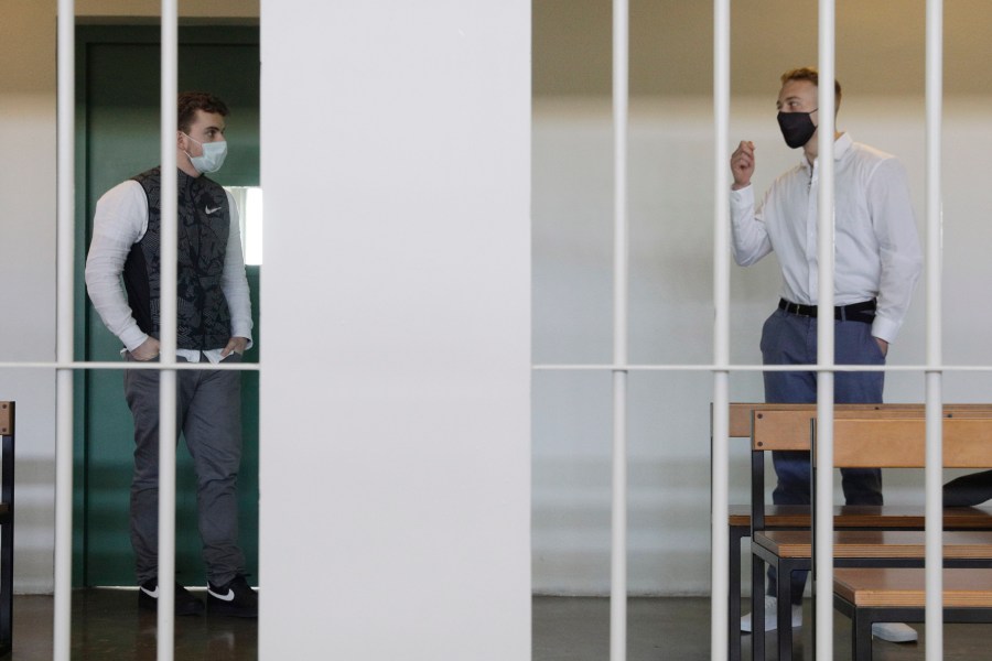 Gabriel Natale-Hjorth, right, talks to his co-defendant Finnegan Lee Elder, before a jury began deliberating their fate as they are on trial for the slaying of an Italian plainclothes police officer on a street near the hotel where they were staying while on vacation in summer 2019, in Rome, on May 5, 2021. (AP Photo/Gregorio Borgia)