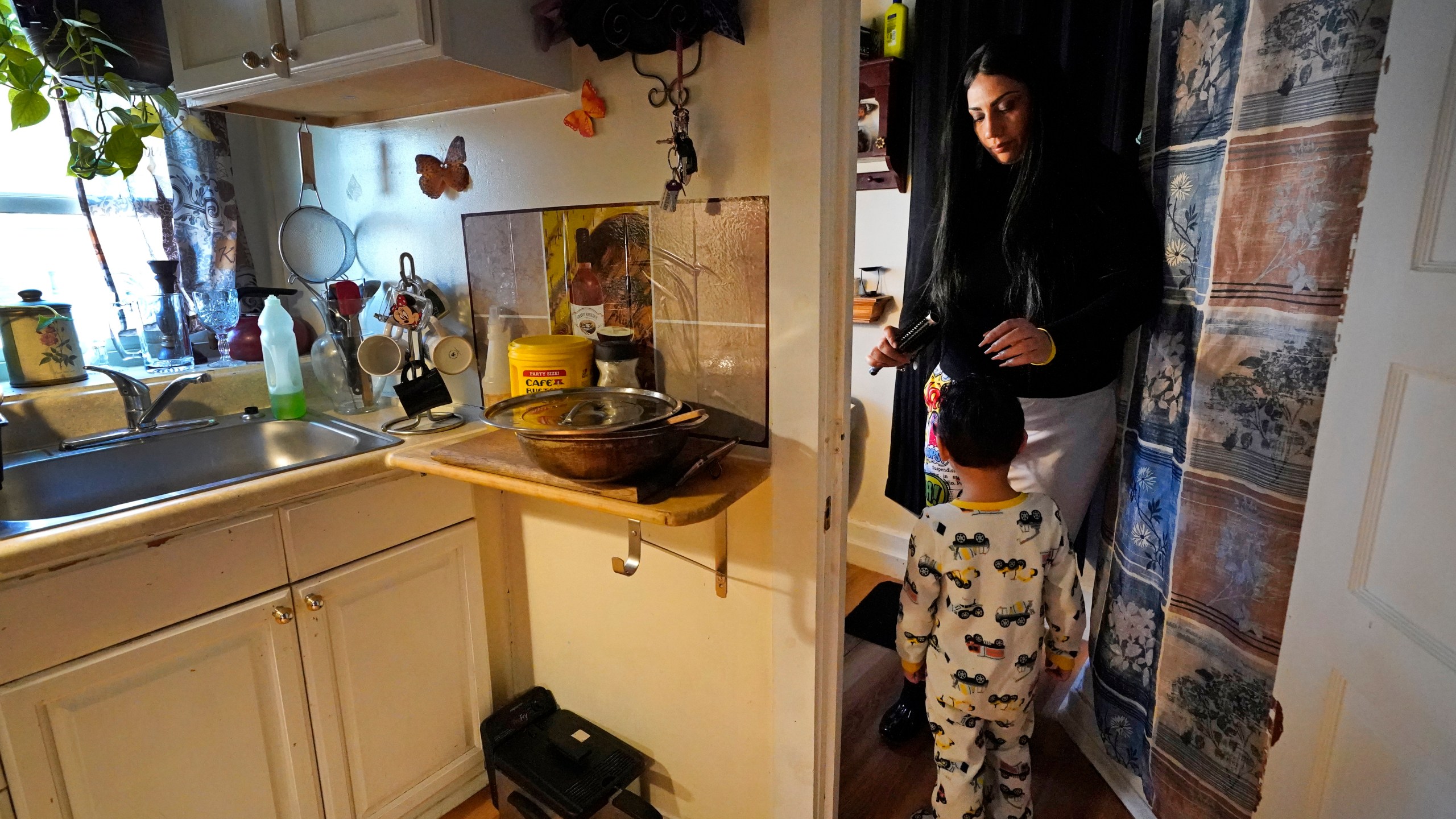 In this March 10, 2021, file photo, Isabel Miranda brushes the hair of her 4-year-old son, Julian, in their rental apartment in Haverhill, Mass. A federal judge has ruled, Wednesday, May 5, 2021, that the Centers for Disease Control exceeded its authority when it imposed a federal eviction moratorium to provide protection for renters out of concern that having families lose their homes and move into shelters or share crowded conditions with relatives or friends during the pandemic would further spread the highly contagious virus. Miranda and her family would no longer have this eviction protection if this ruling stands. (AP Photo/Elise Amendola, File)