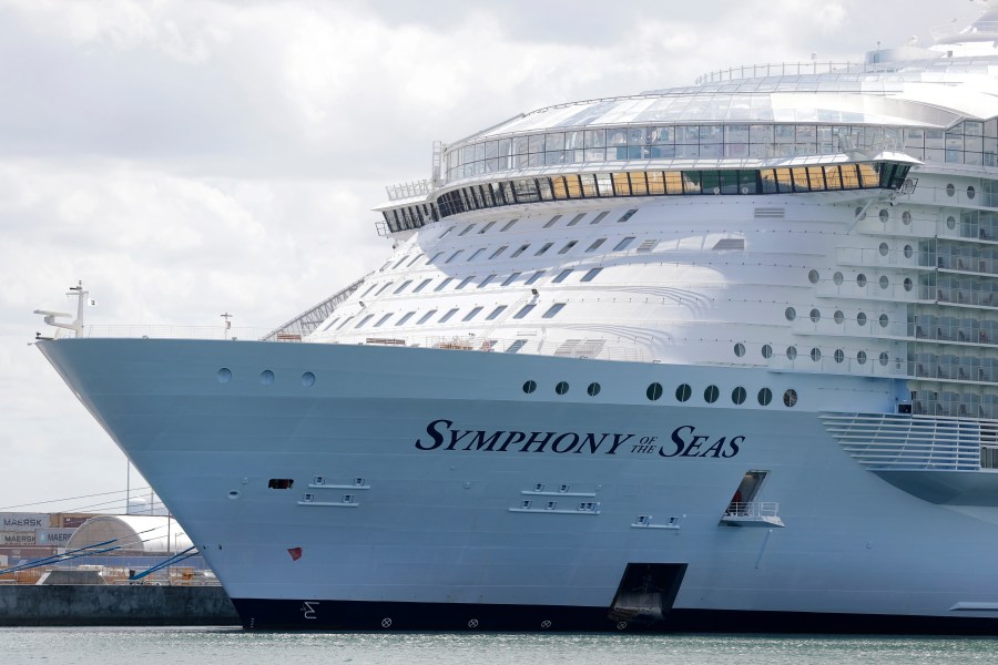 The Symphony of the Seas cruise ship is shown docked at PortMiami, in a Wednesday, May 20, 2020, file photo, in Miami. Cruise lines can soon begin trial voyages in U.S. waters. They'll have to carry some volunteer passengers, who will have to wear face masks and observe social distancing while on board. The Centers for Disease Control and Prevention gave ship operators final technical guidelines Wednesday, May 5, 2021 for the trial runs. (AP Photo/Wilfredo Lee, File)