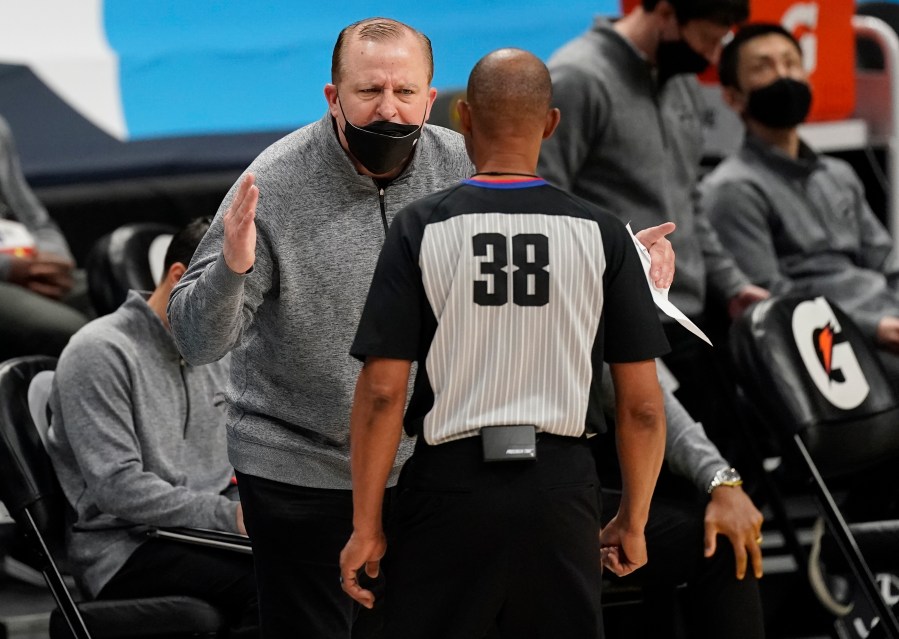 New York Knicks head coach Tom Thibodeau, back, argues for a call with referee Michael Smith in the second half of an NBA basketball game against the Denver Nuggets Wednesday, May 5, 2021, in Denver. (AP Photo/David Zalubowski)