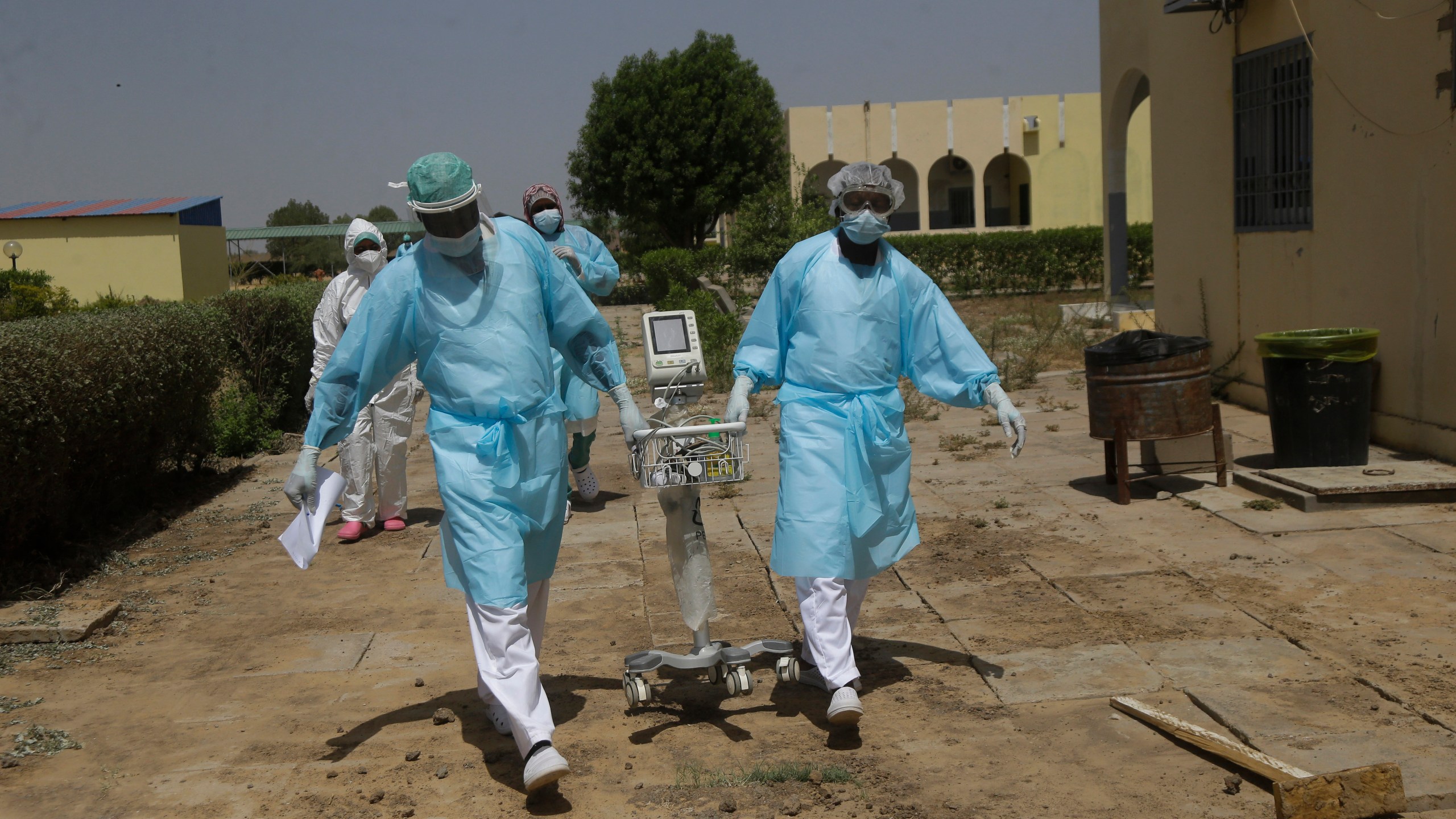 Doctors caring with COVID-19 patients ferry medical equipment, at the Farcha provincial hospital in N'Djamena, Chad, Friday April 30, 2021. (AP Photo/Sunday Alamba)