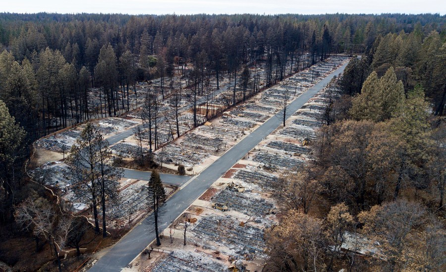 In this Dec. 3, 2018, file photo, charred footprints of homes leveled by the Camp Fire line the streets at the Ridgewood Mobile Home Park retirement community in Paradise, Calif. (AP Photo/Noah Berger, File)