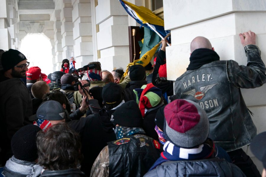 In this Jan. 6, 2021 file photo insurrectionists loyal to President Donald Trump try to open a door of the U.S. Capitol as they riot in Washington. (AP Photo/Jose Luis Magana, File)