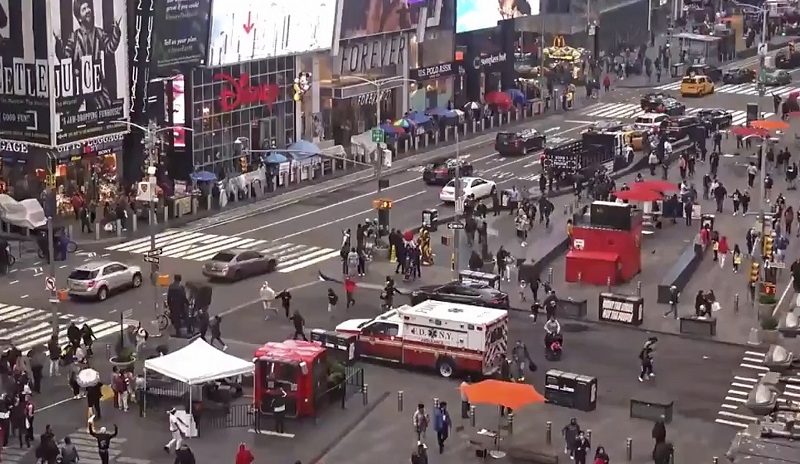 In this image taken from video by the FDNY, pedestrians hurry away from the scene of a shooting in Times Square, Saturday, May 8, 2021, in New York. New York City police say three innocent bystanders including a 4-year-old girl who was toy shopping have been shot in Times Square and officers are looking for suspects. All the victims are expected to recover. (FDNY via AP)