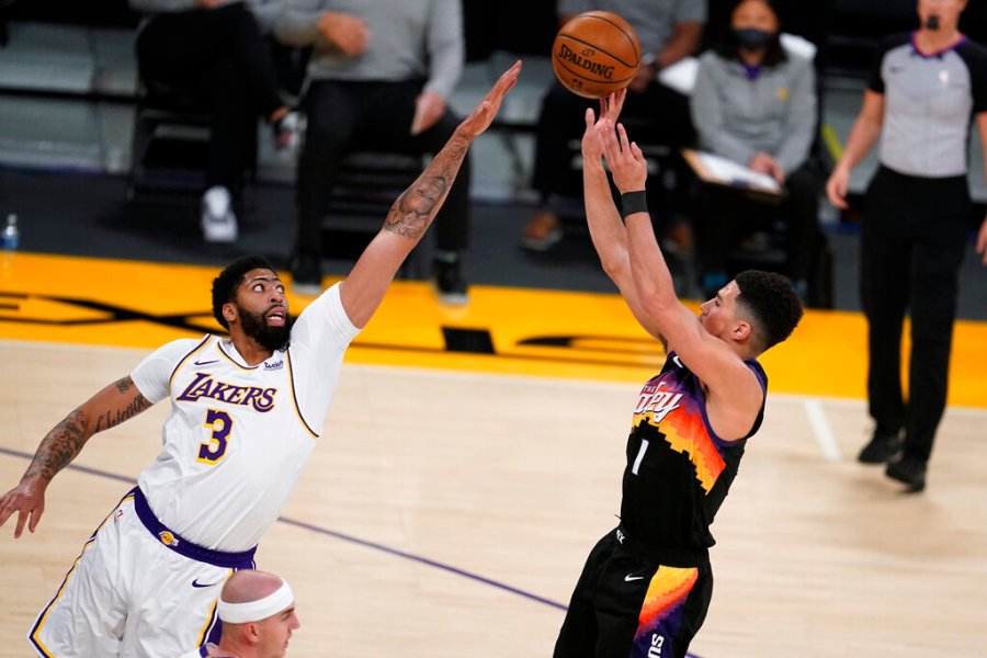 Phoenix Suns guard Devin Booker, right, shoots over Los Angeles Lakers forward Anthony Davis (3) during the first half of an NBA basketball game Sunday, May 9, 2021, in Los Angeles. (AP Photo/Marcio Jose Sanchez)