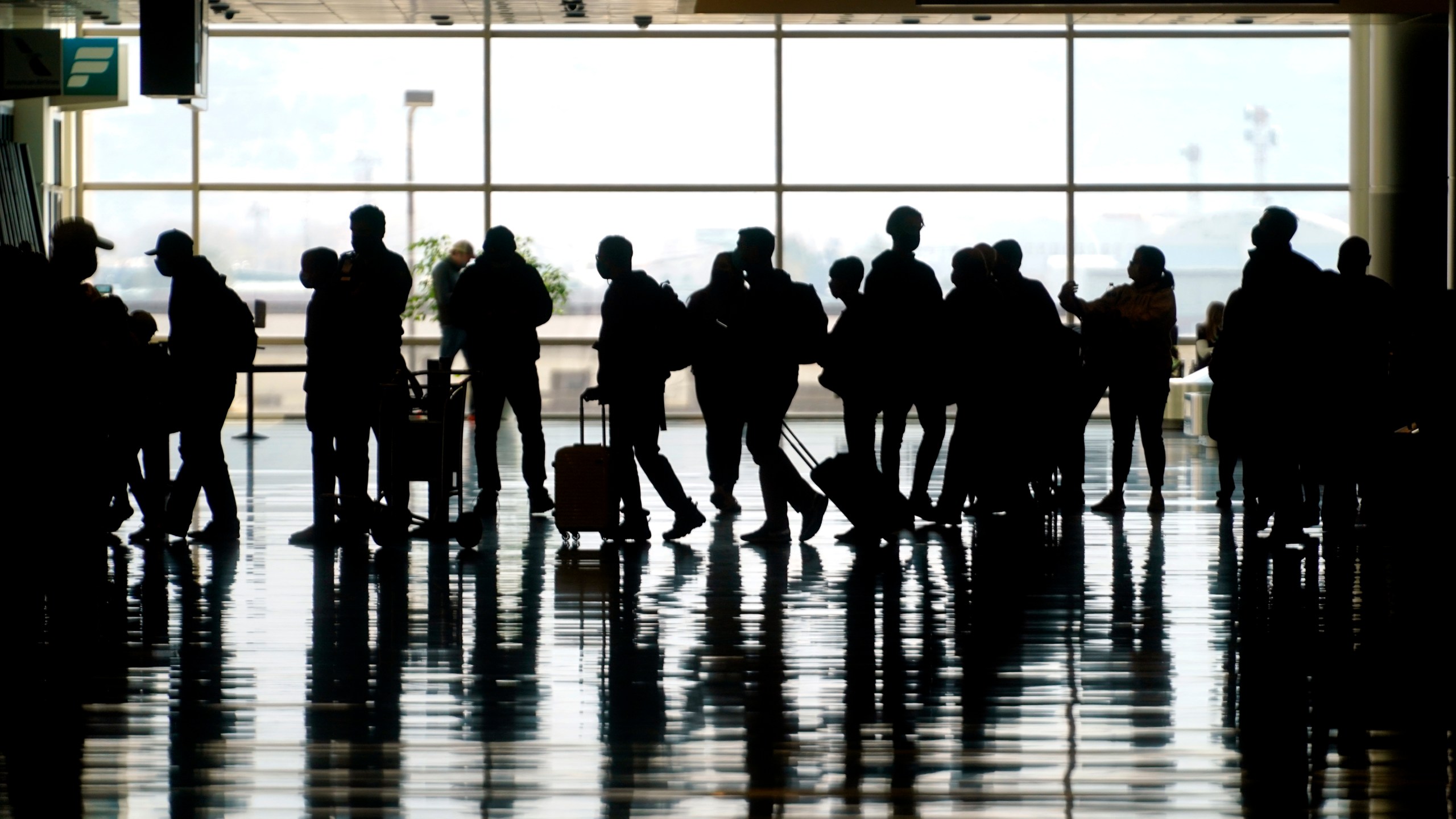 Travelers walk through the Salt Lake City International Airport in Salt Lake City on March 17, 2021. (Rick Bowmer / Associated Press)