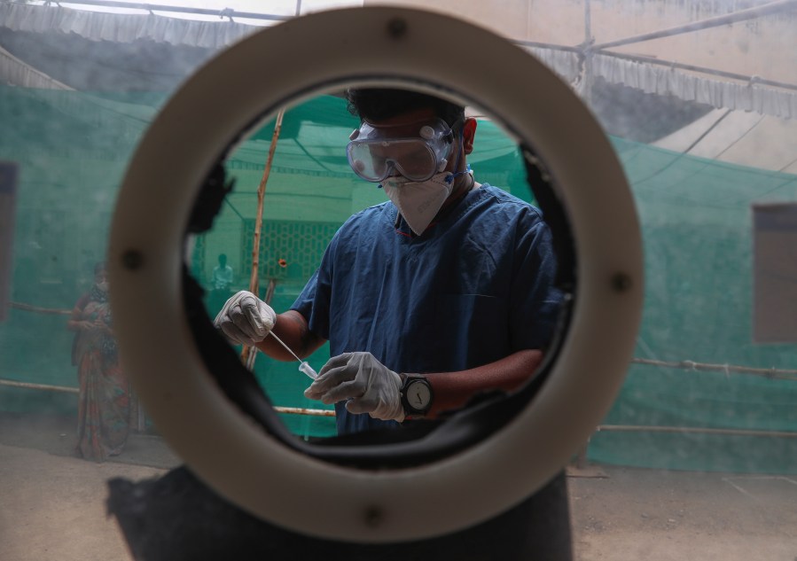 In this April 12, 2021, file photo, health worker collects nasal swab samples at a COVID-19 testing center in Hyderabad, India. The World Health Organization said Monday, May 10, that a worrisome variant was first detected in India may spread more easily. Scientists are still trying to figure out if it resulted in the terrifying surge of infections in the nation, and looking to see if this could this happen elsewhere. (AP Photo/Mahesh Kumar A., File)