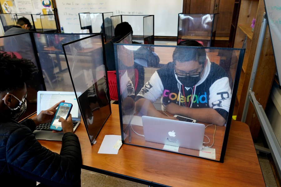 Senior Jose Solano-Hernandez, right, studies with classmates on the first day of in-person learning at Wyandotte High School in Kansas City, Kan., Wednesday, March 30, 2021. (AP Photo/Charlie Riedel)