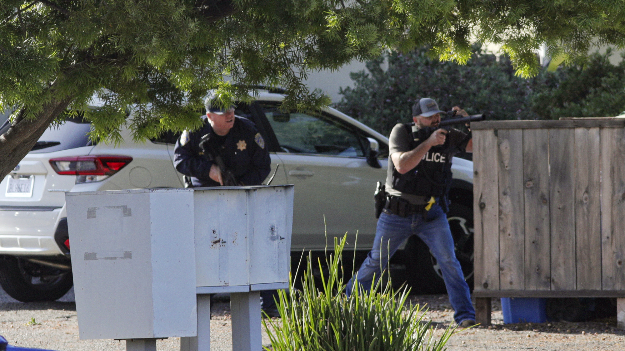 Officers take aim at an apartment across Camilla Court, Monday, May 10, 2021, in San Luis Obispo, Calif. (David Middlecamp/The Tribune (of San Luis Obispo via AP)