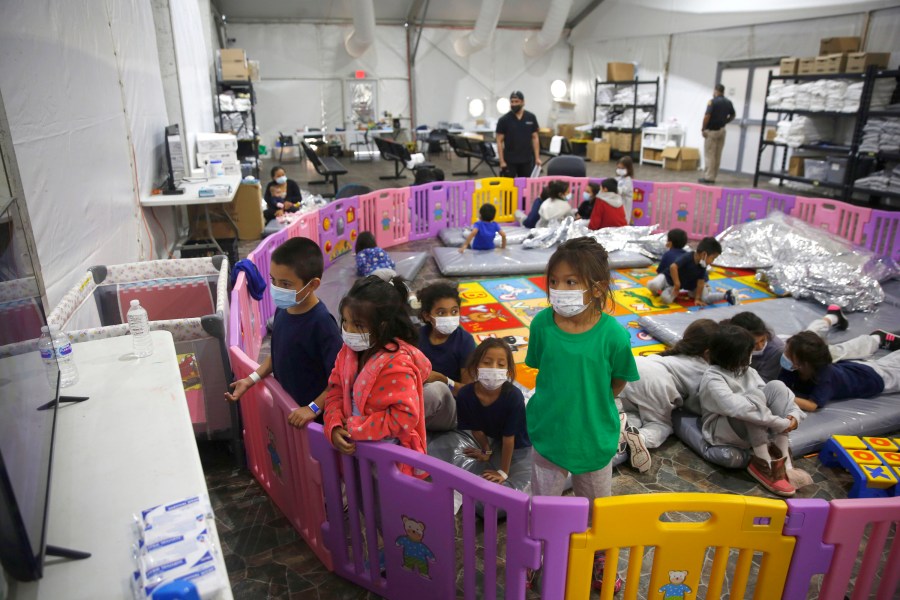 Young unaccompanied migrants watch television inside a playpen at the U.S. Customs and Border Protection facility, the main detention center for unaccompanied children in the Rio Grande Valley, in Donna, Texas, on March 30, 2012. (Dario Lopez-Mills / Associated Press)