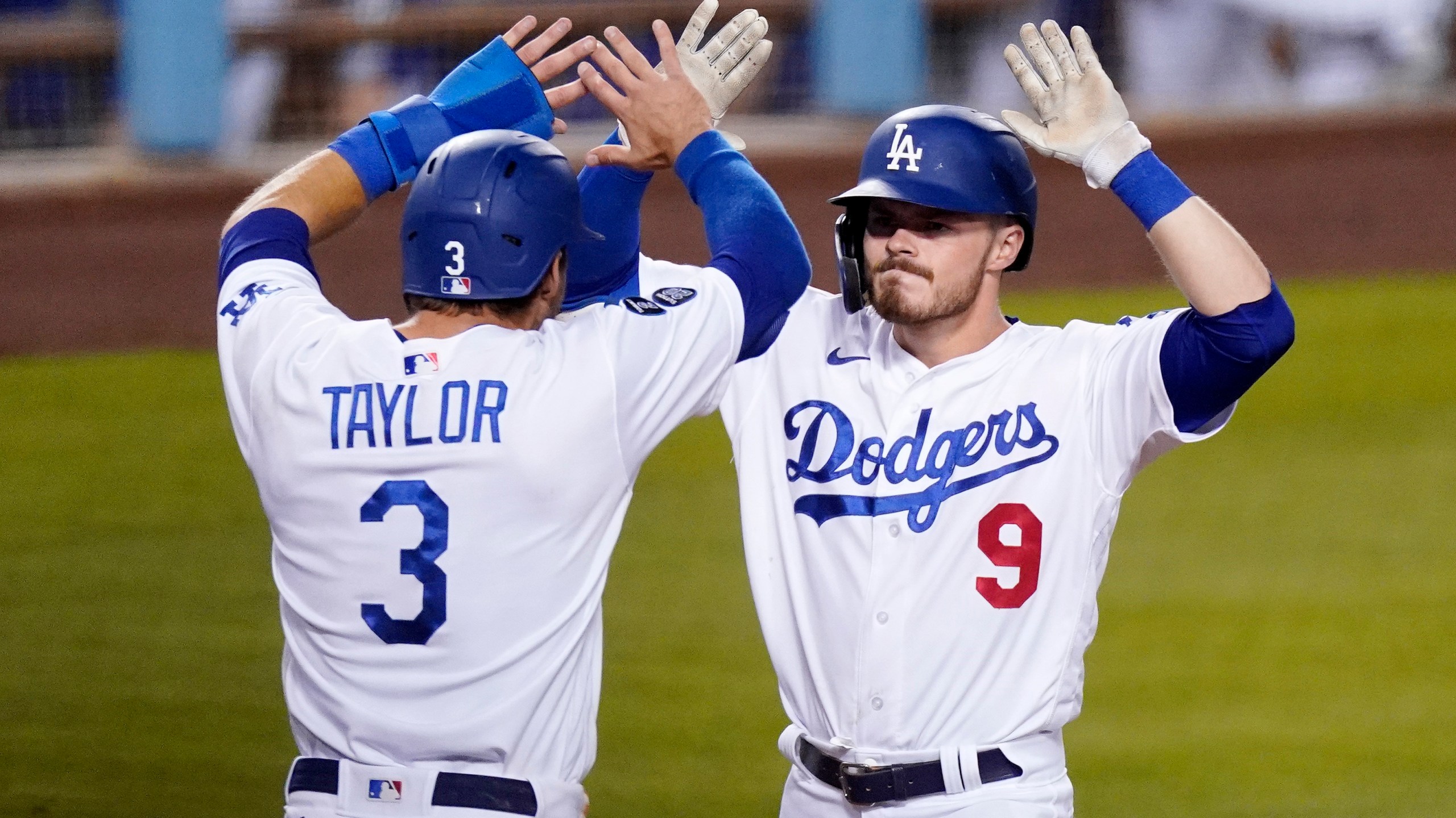 Los Angeles Dodgers' Gavin Lux, right, is congratulated by Chris Taylor after hitting a three-run home run during the eighth inning of an interleague baseball game against the Seattle Mariners on May 11, 2021, in Los Angeles. (AP Photo/Mark J. Terrill)