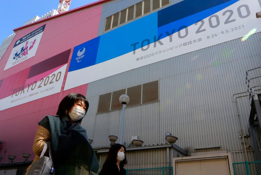 In this Feb. 24, 2021, file photo, people walk past posters to promote the Olympic Games scheduled to start in the summer in Tokyo. (AP Photo/Koji Sasahara, File)