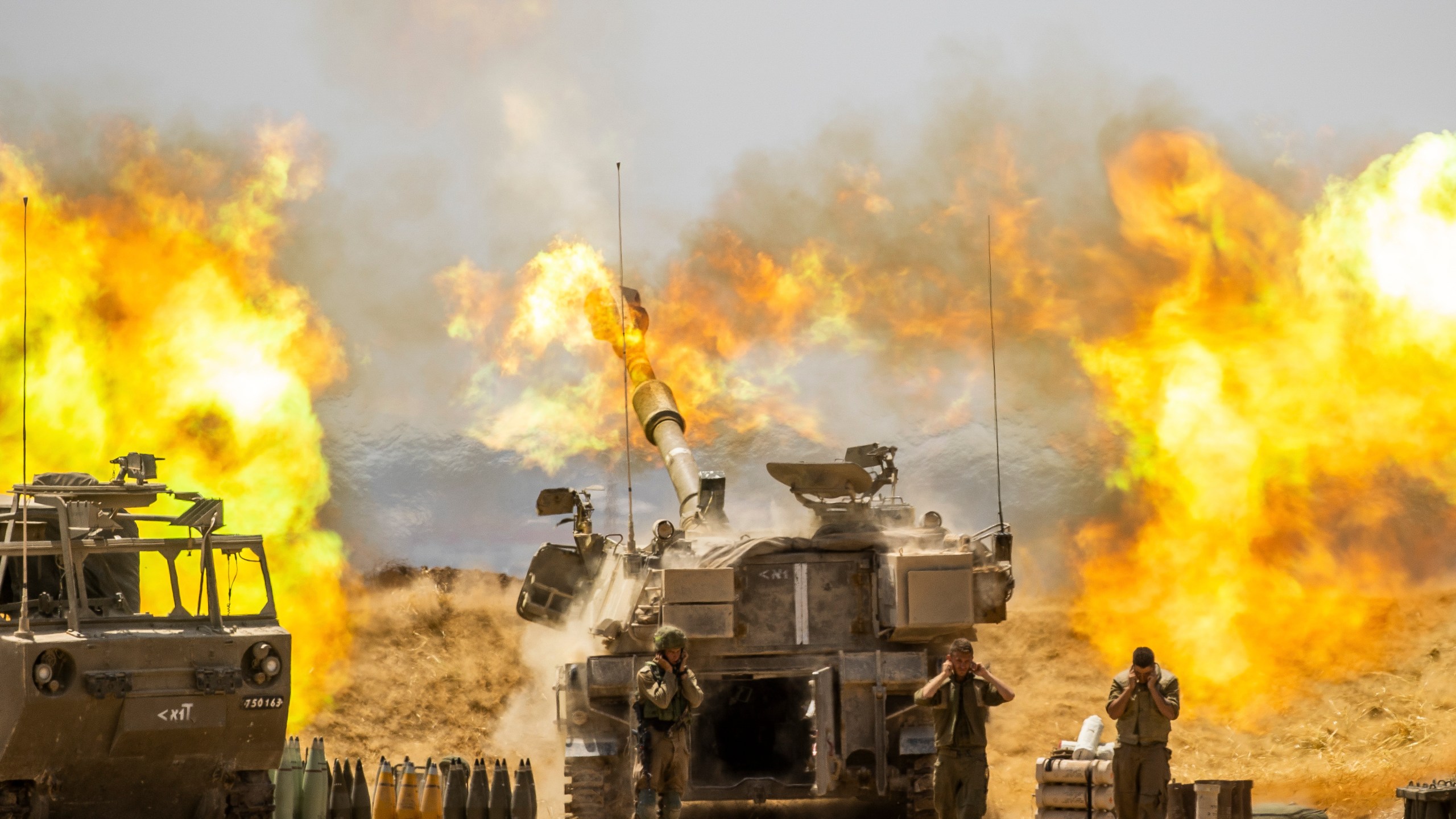 An Israeli artillery unit fires toward targets in Gaza Strip, at the Israeli Gaza border, on May 12, 2021. (Yonatan Sindel / Associated Press)