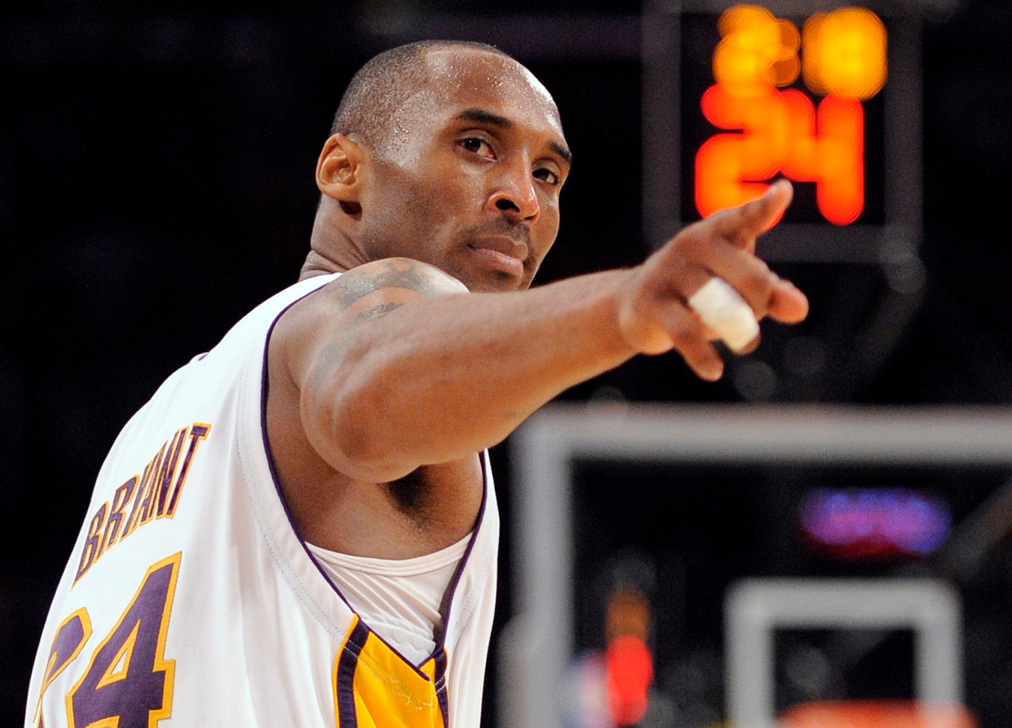 In this June 7, 2009, file photo, Los Angeles Lakers guard Kobe Bryant (24) points to a player behind him after making a basket in the closing seconds against the Orlando Magic in Game 2 of the NBA basketball finals, in Los Angeles. (AP Photo/Mark J. Terrill, File)