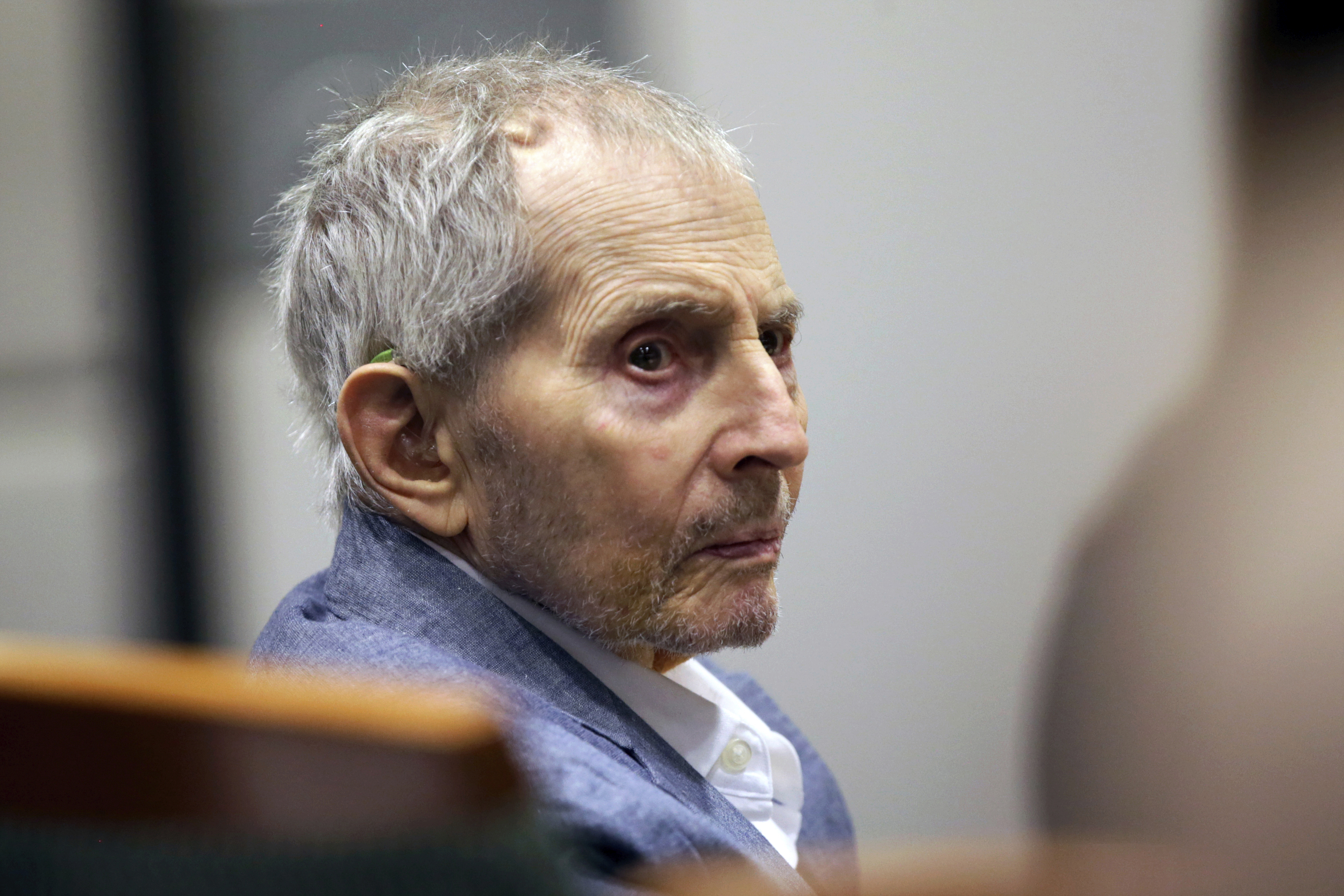 In this March 10, 2020 file photo, real estate heir Robert Durst looks over during his murder trial in Los Angeles. Fourteen months after the murder trial of New York real estate heir Durst was put on hold because of the coronavirus pandemic, jurors are returning to court to see if they can finish the assignment they were given. A Los Angeles judge will question jurors Monday, May 17, 2021, to find out if they can continue to serve in the case that is expected to last four to five months. (Alex Gallardo/Associated Press, Pool)