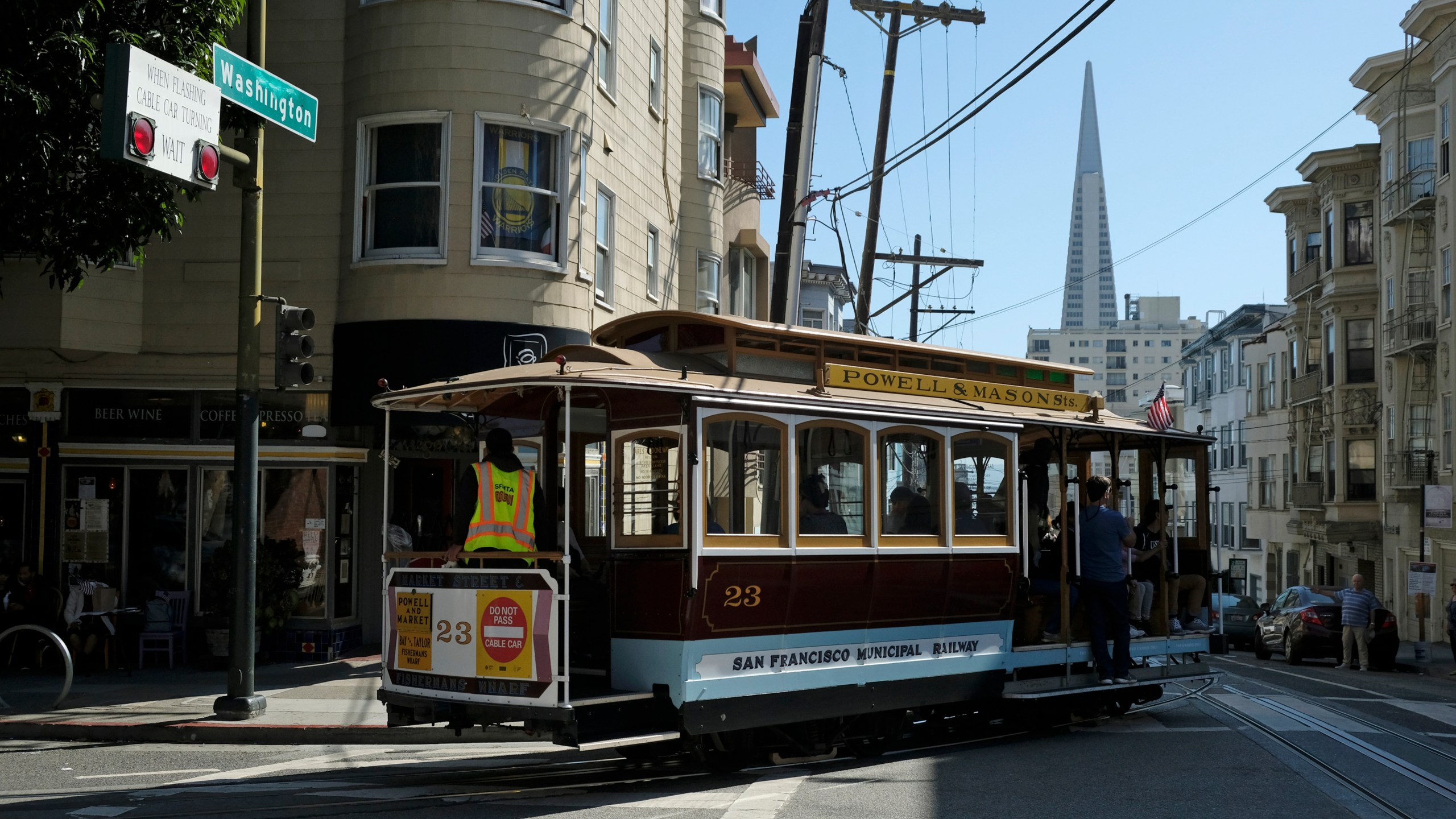 In this Sept. 11, 2019, file photo, a cable car turns onto Washington Street with the Transamerica Pyramid in the background in San Francisco. (AP Photo/Eric Risberg, File)