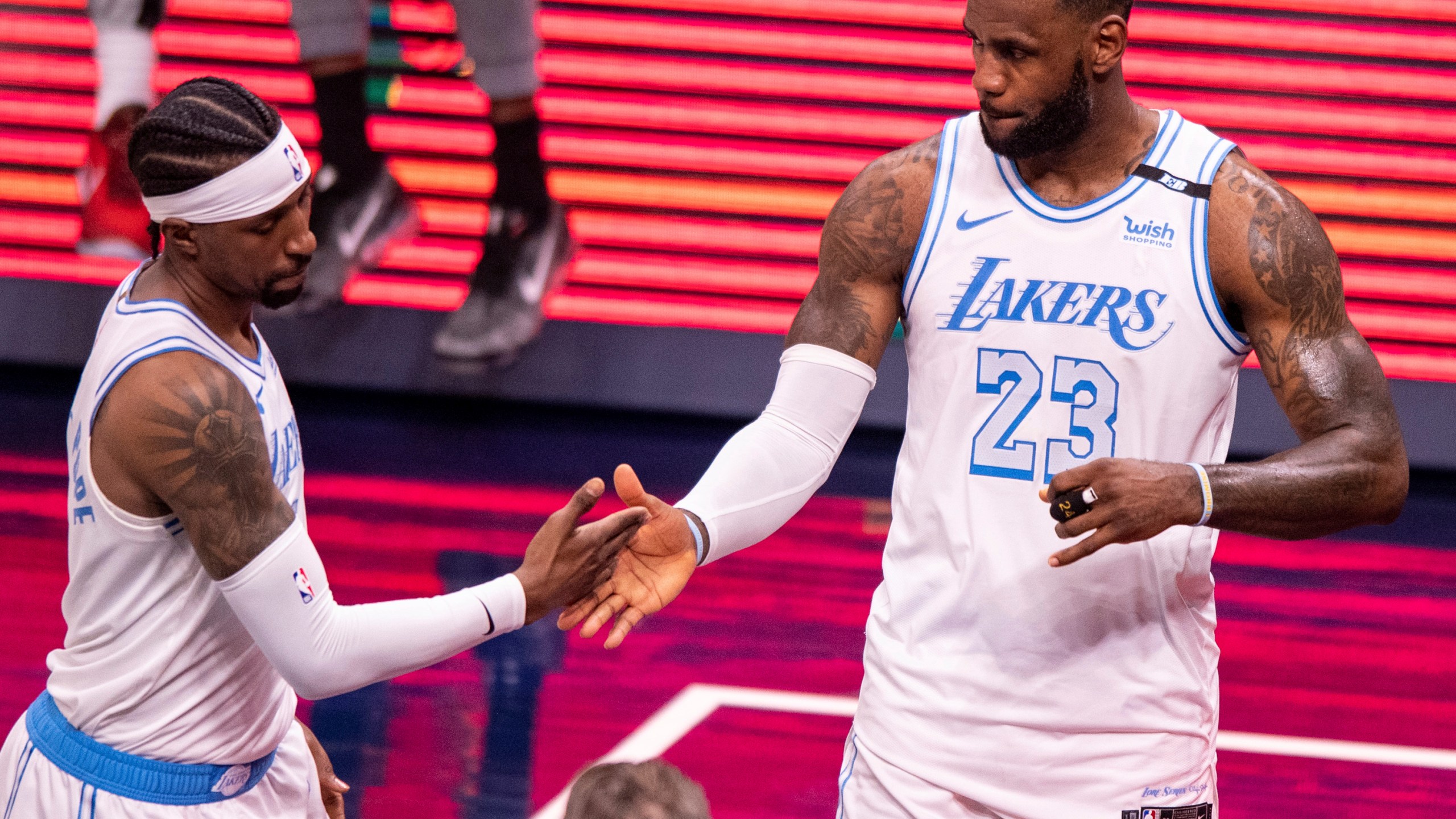 Los Angeles Lakers guard Kentavious Caldwell-Pope, left, and forward LeBron James (23) reacts after defeating the Indiana Pacers in an NBA basketball game in Indianapolis, Saturday, May 15, 2021. (AP Photo/Doug McSchooler)