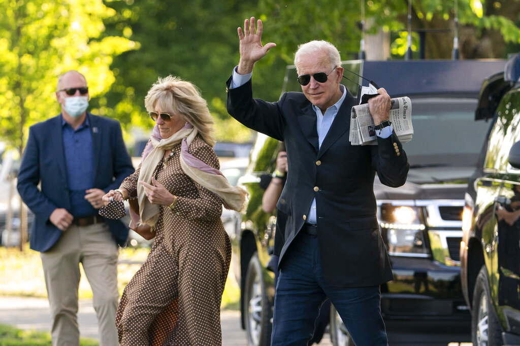 President Joe Biden with first lady Jill Biden waves as they walk on the Ellipse near the White House in Washington to board the Marine One, Saturday, May 15, 2021. (AP Photo/Manuel Balce Ceneta)