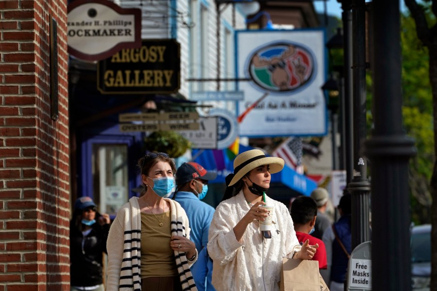 Visitors walk on a busy sidewalk, Saturday, May 15, 2021, in Bar Harbor, Maine. Gov. Janet Mills is is eliminating most outdoor distancing requirements imposed during the COVID-19 pandemic as the tourism season begins to kick into gear. (AP Photo/Robert F. Bukaty)