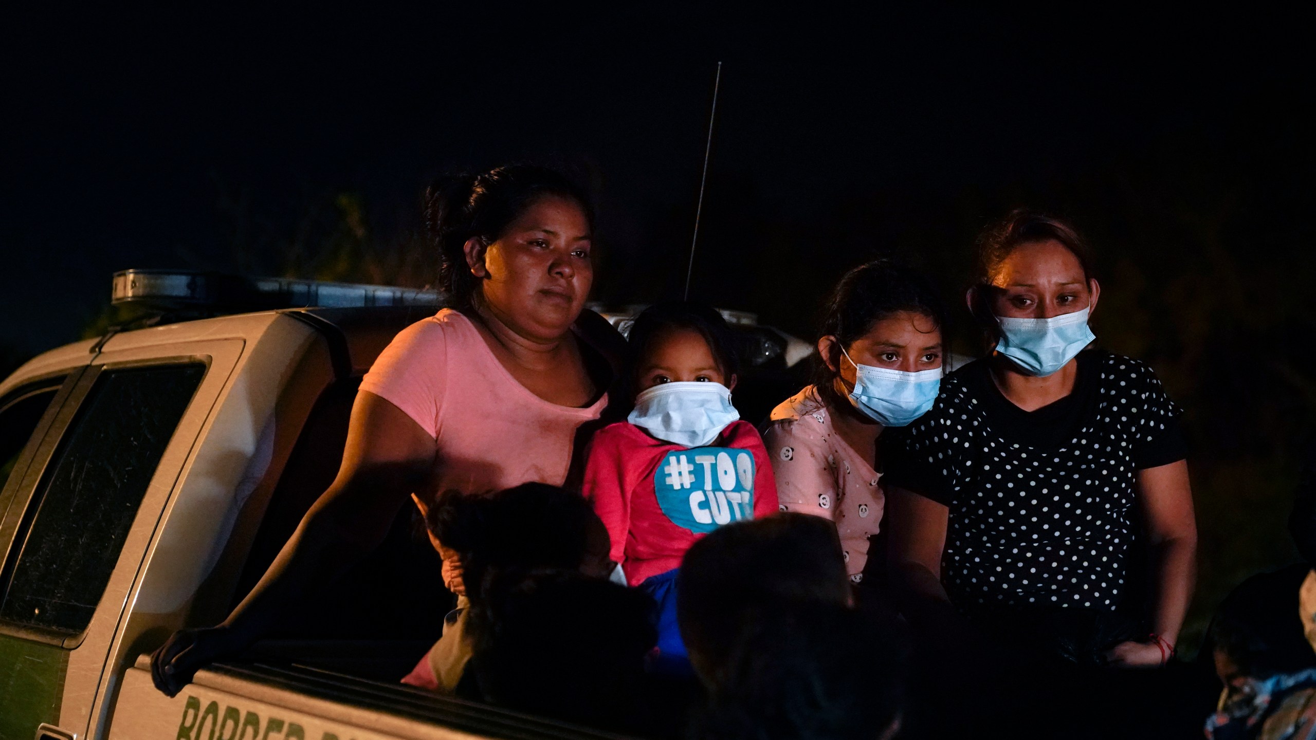 Migrants from Honduras wait in a Border Patrol truck after turning themselves in upon crossing the U.S.-Mexico border in La Joya, Texas, on May 17, 2021. (Gregory Bull / Associated Press)