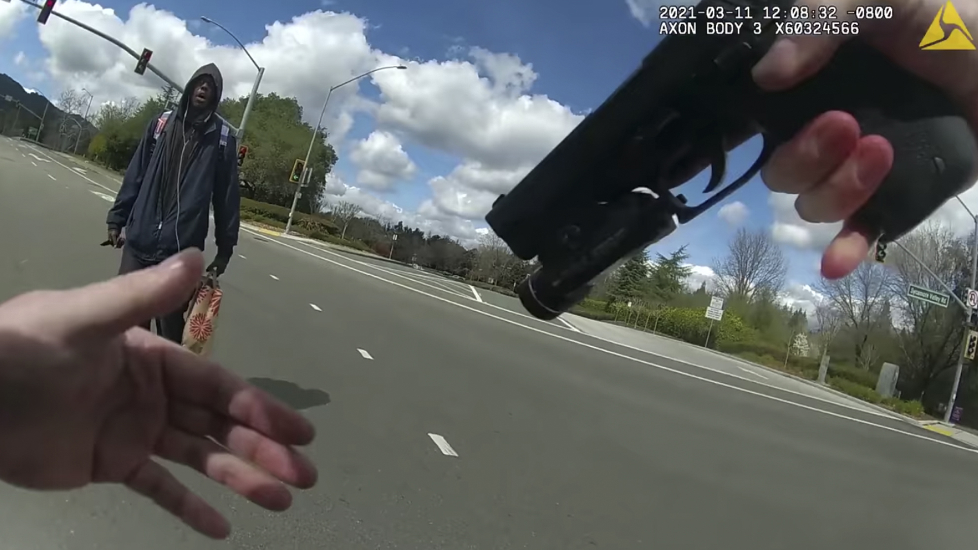 This image from body-worn camera video provided by the Contra Costa County Sheriff’s Office shows Tyrell Wilson, left, holding a knife in his right hand, in front of Officer Andrew Hall in the middle of an intersection on March 11, 2021, in Danville, Calif.(Contra Costa Sheriff via Associated Press)