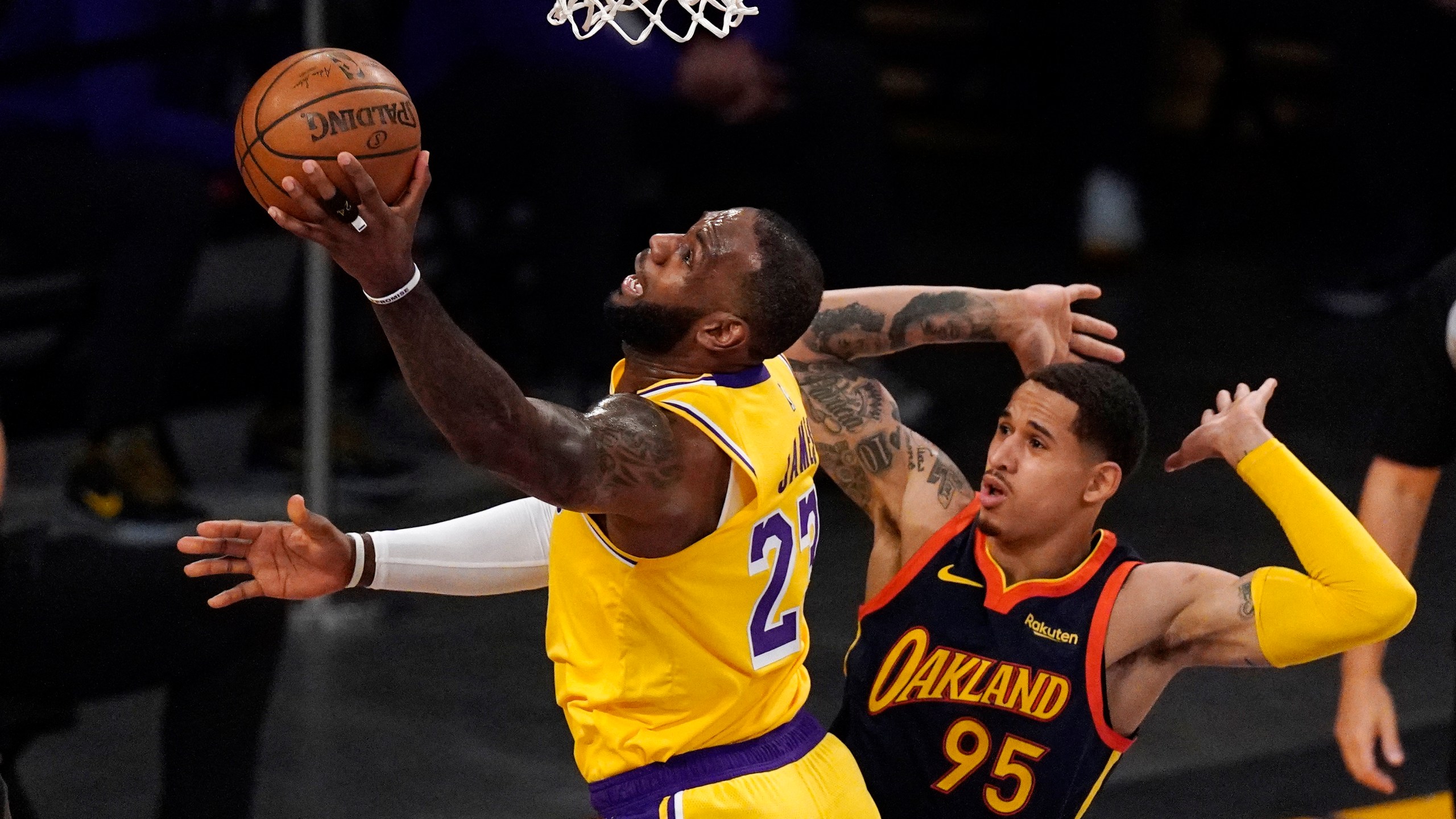 Los Angeles Lakers forward LeBron James, left, shoots as Golden State Warriors forward Juan Toscano-Anderson defends during the first half of an NBA basketball Western Conference Play-In game on May 19, 2021, in Los Angeles. (AP Photo/Mark J. Terrill)