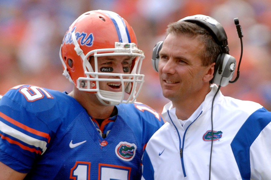 In this Oct. 25, 2008, file photo, Florida quarterback Tim Tebow (15) shares a laugh with coach Urban Meyer during the fourth quarter of an NCAA college football game against Kentucky in Gainesville, Fla. Tebow and Meyer are together again, this time in the NFL and with Tebow playing a new position. The former Florida star and 2007 Heisman Trophy-winning quarterback signed a one-year contract with the Jacksonville Jaguars on Thursday, May 20, 2021, and will attempt to revive his pro career as a tight end. (AP Photo/Phil Sandlin, File)