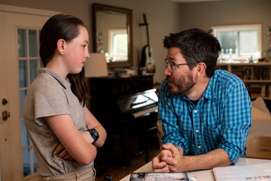 Jay Wamsted, right, and his daughter, Kira, are photographed on Thursday, May 20, 2021 in Smyrna, Ga. Wamsted, who is an 8th grade math teacher allowed his daughter to skip testing this year. (AP Photo/Ben Gray)