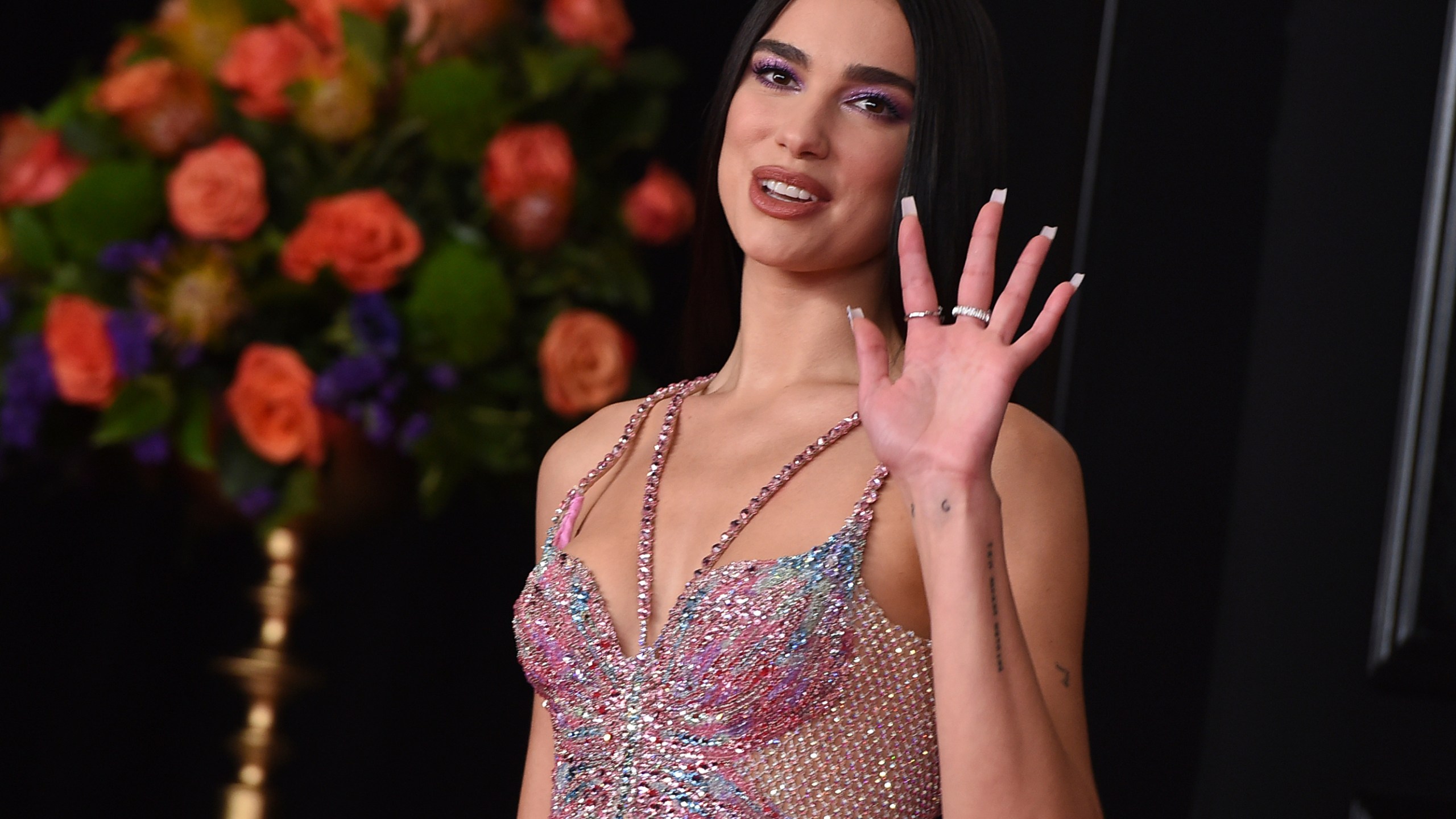 In this Sunday, March 14, 2021 file photo, Dua Lipa arrives at the 63rd annual Grammy Awards at the Los Angeles Convention Center. Singer Dua Lipa is blasting the organization which paid for a full-page ad in The New York Times that called her antisemitic for her support of Palestinians, saying it used her name “shamelessly” to “advance their ugly campaign with falsehoods and blatant misrepresentations.” Lipa took to Twitter on Saturday, May 22, 2021 to “reject the false and appalling allegations” and said the World Values Network twisted what she stands for. “I stand in solidarity with all oppressed people and reject all forms of racism,” she wrote. (Photo by Jordan Strauss/Invision/AP, File)