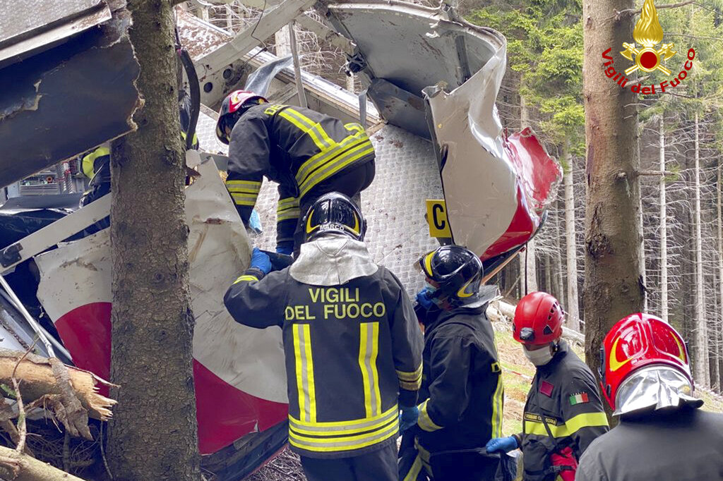 Rescuers work by the wreckage of a cable car after it collapsed near the summit of the Stresa-Mottarone line in the Piedmont region, northern Italy, Sunday, May 23, 2021. (Vigili del Fuoco Firefighters via AP)