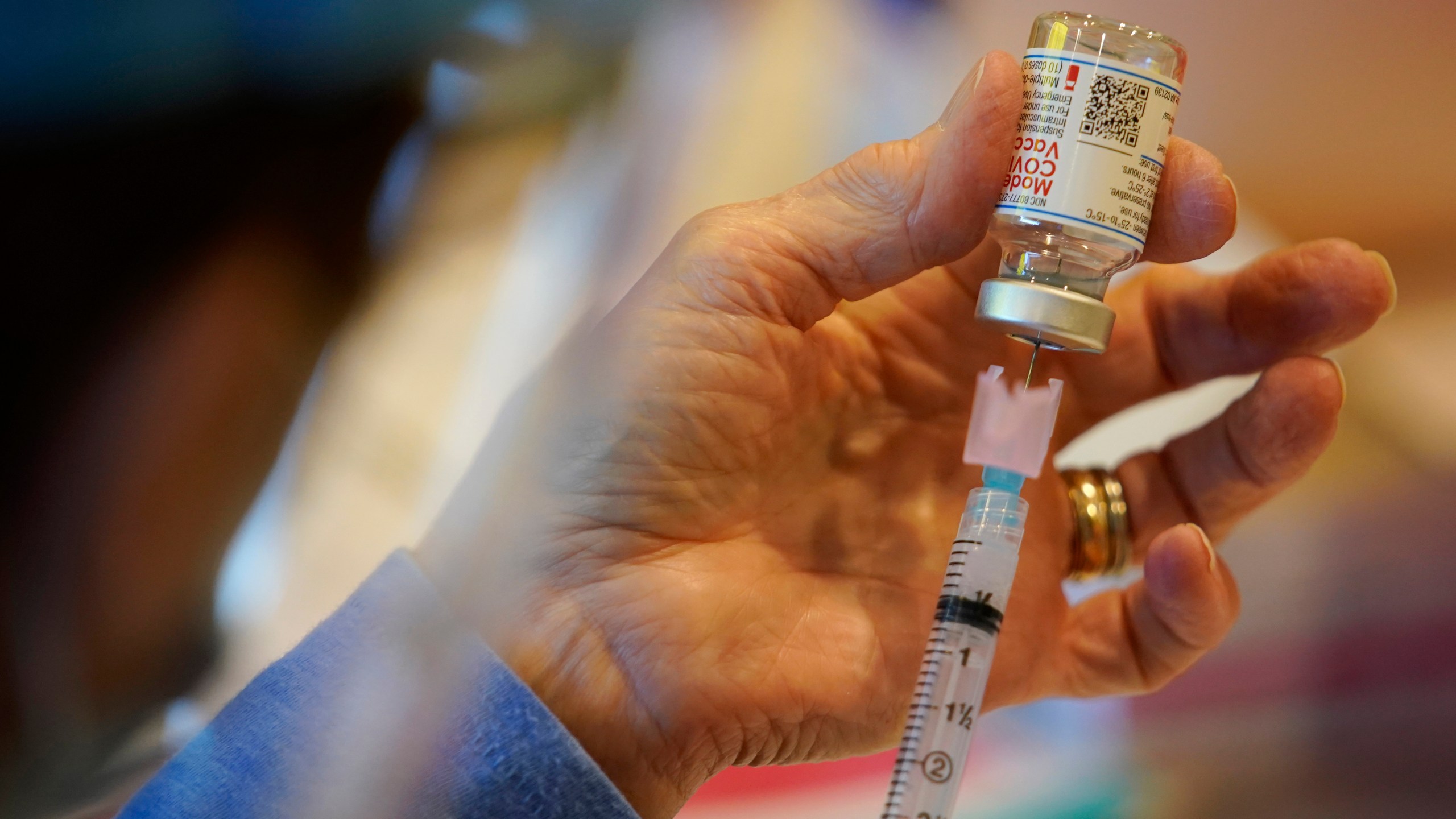 In this Dec. 29, 2020, file photo, Pat Moore, with the Chester County, Pa., Health Department, fills a syringe with Moderna COVID-19 vaccine before administering it to emergency medical workers and health care personnel at the Chester County Government Services Center in West Chester, Pa. (AP Photo/Matt Slocum, File)