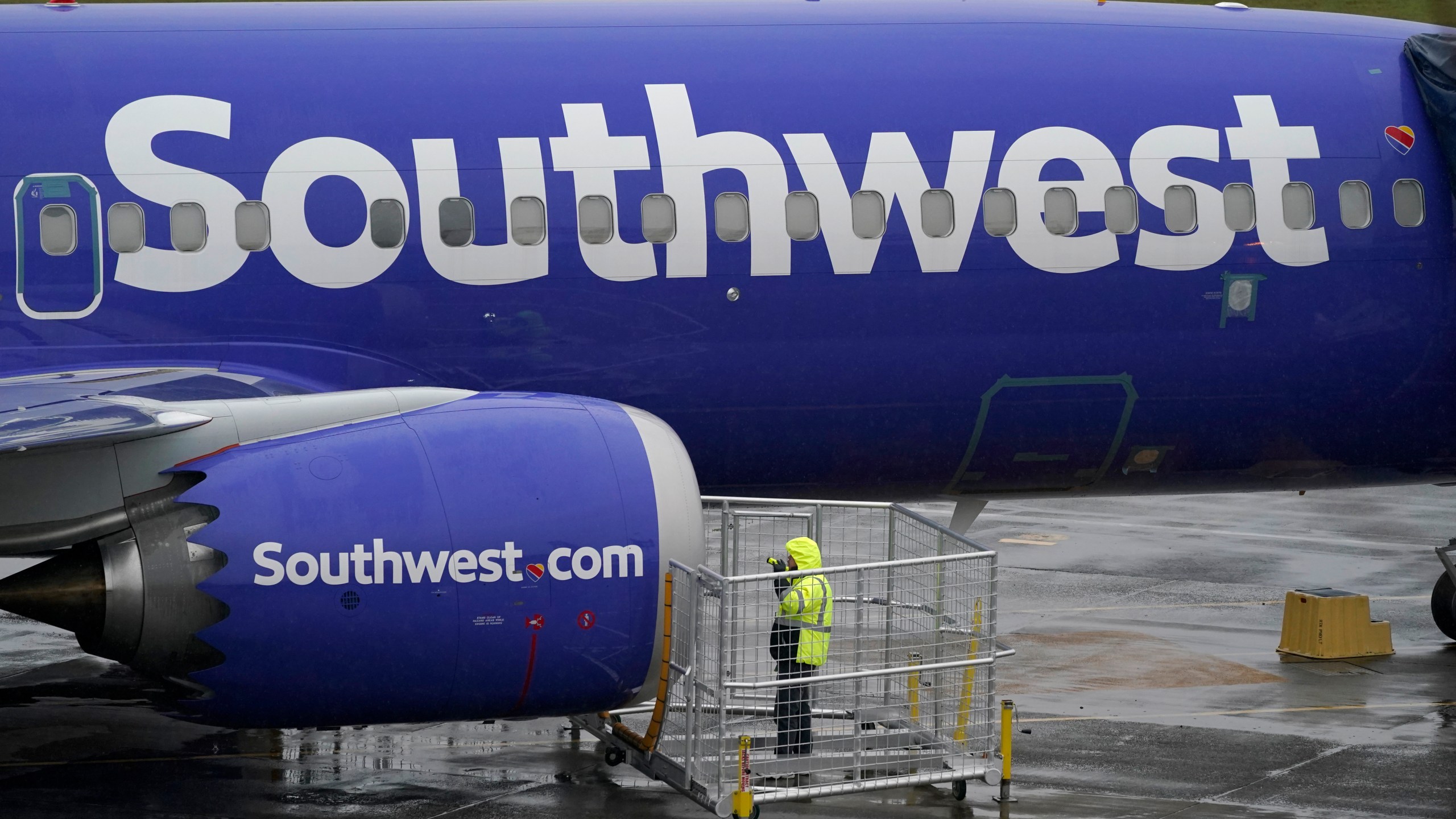 In this Nov. 18, 2020 file photo, a worker uses a flashlight to inspect an engine on a Boeing 737 Max 8 built for Southwest Airlines at Renton Municipal Airport in Renton, Wash. (AP Photo/Ted S. Warren, File)