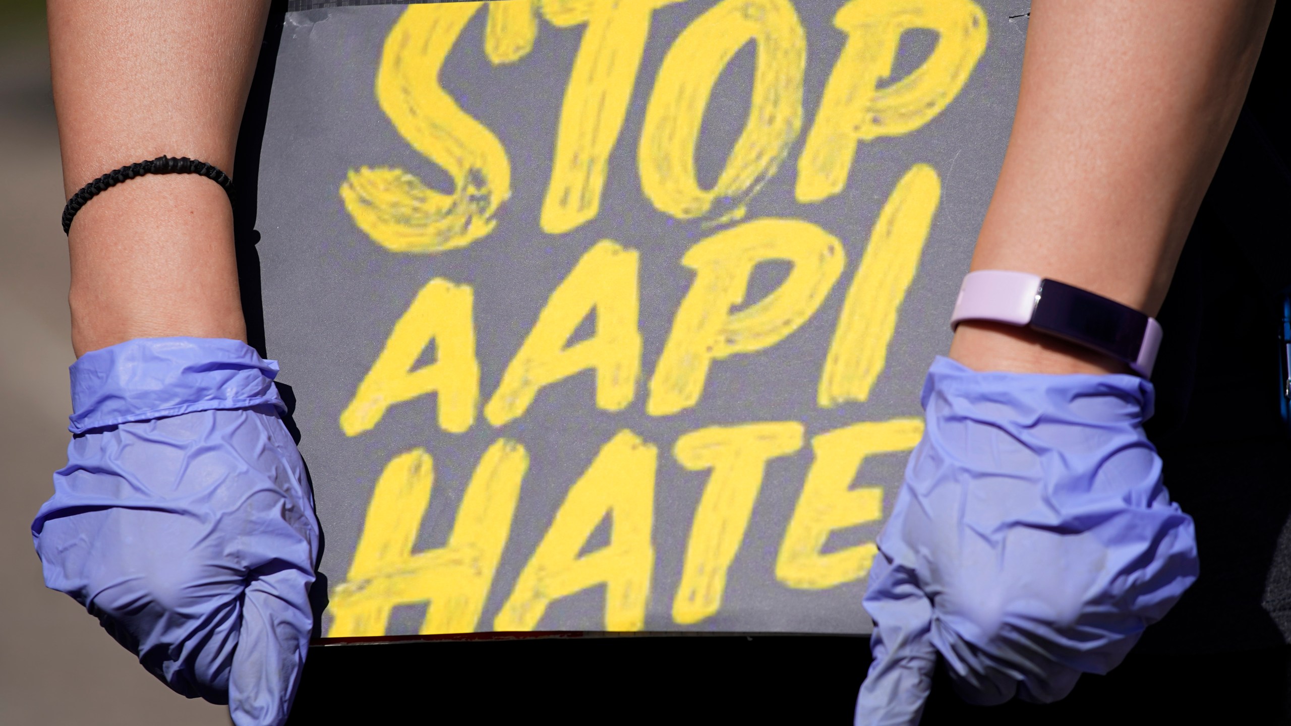 In this March 20, 2021, file photo, woman holds a sign and attends a rally to support stop AAPI hate at the Logan Square Monument in Chicago. (Nam Y. Huh/Associated Press)