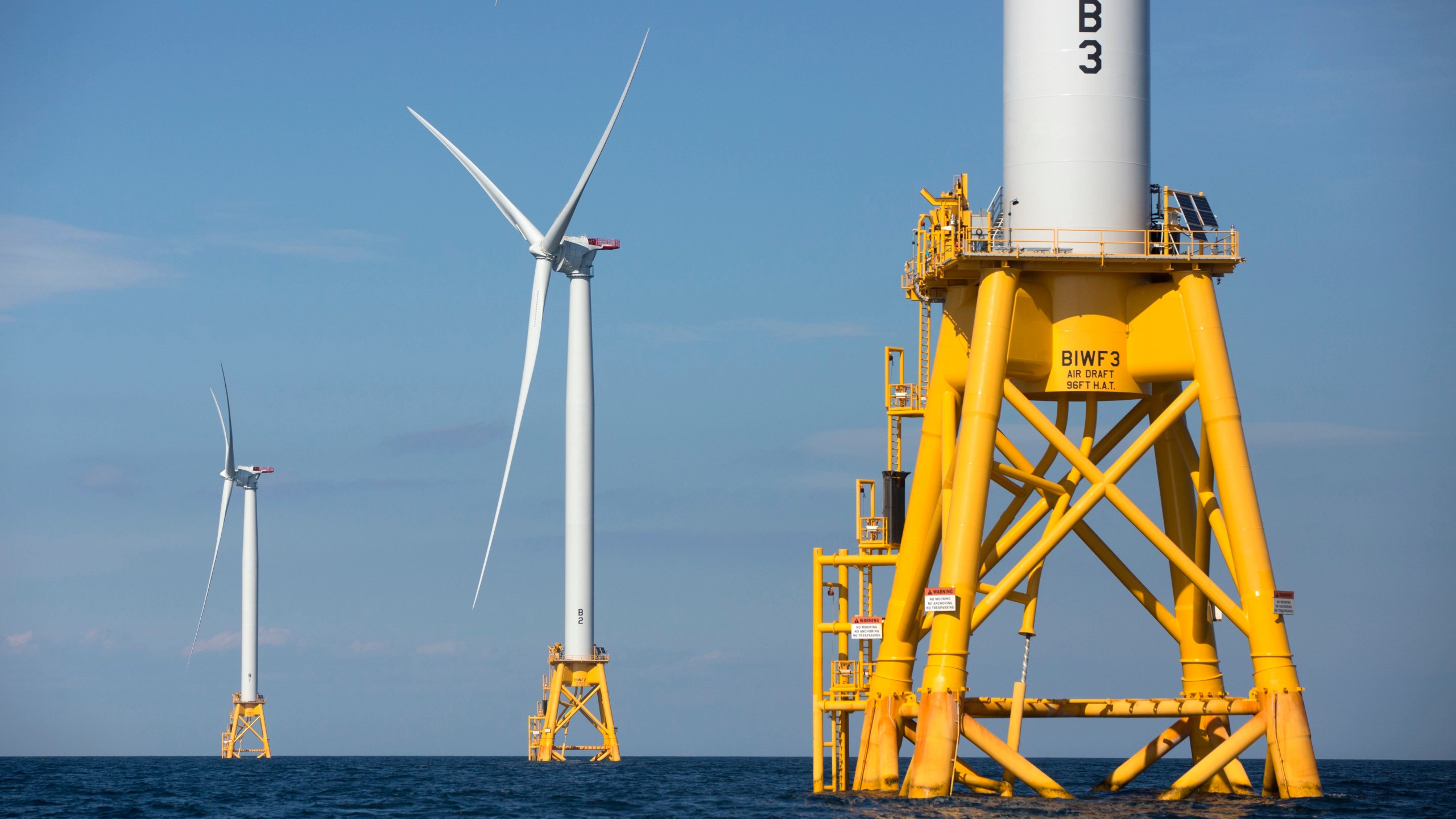 In this Aug. 15, 2016 file photo, three of Deepwater Wind's five turbines stand in the water off Block Island, R.I, the nation's first offshore wind farm. California and the federal government have agreed to open up areas off the central and northern coasts to massive wind farms. The pact announced Tuesday, May 25, 2021, that would float hundreds of turbines off the coast of Morro Bay and Humboldt Bay was touted as a breakthrough to eventually power 1.6 million homes. (AP Photo/Michael Dwyer, File)