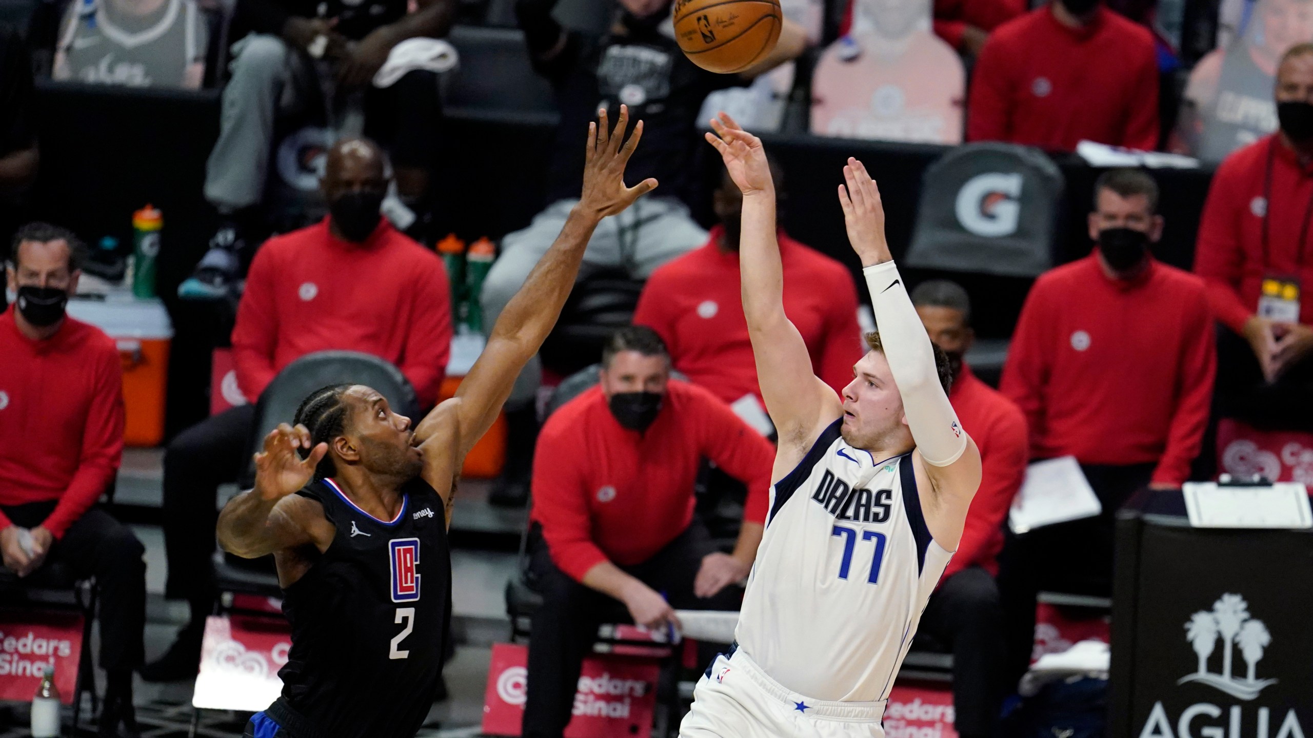 Dallas Mavericks guard Luka Doncic (77) scores over Los Angeles Clippers forward Kawhi Leonard (2) during the second half in Game 2 of an NBA basketball first-round playoff series on May 25, 2021, in Los Angeles. (AP Photo/Marcio Jose Sanchez)