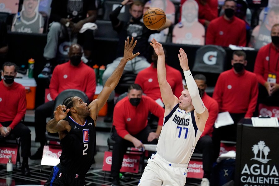 Dallas Mavericks guard Luka Doncic (77) scores over Los Angeles Clippers forward Kawhi Leonard (2) during the second half in Game 2 of an NBA basketball first-round playoff series on May 25, 2021, in Los Angeles. (AP Photo/Marcio Jose Sanchez)