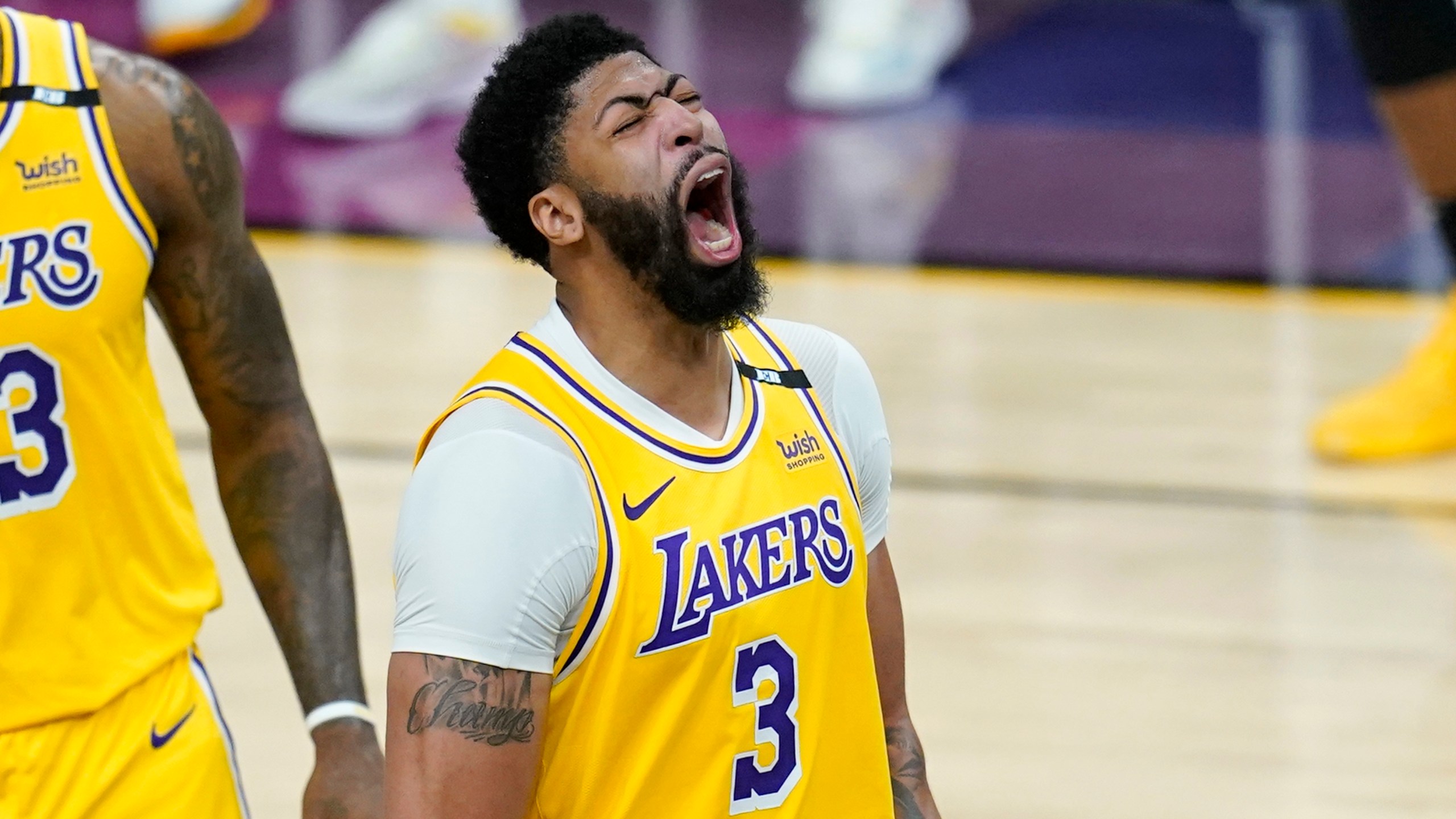 Los Angeles Lakers forward Anthony Davis shouts as he celebrates a stop against the Phoenix Suns during the second half of Game 2 of an NBA basketball first-round playoff series on May 25, 2021, in Phoenix. The Lakers defeated the Suns 109-102. (AP Photo/Ross D. Franklin)