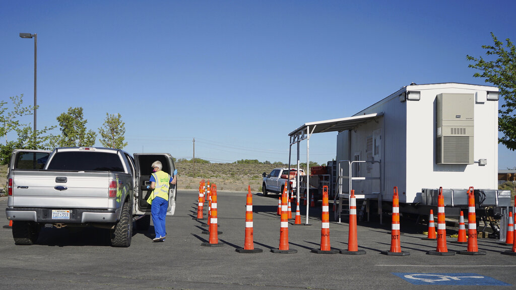 Peggy Franklin, a volunteer nurse from Reno, administers vaccines at a mobile vaccination clinic held at a tribal health center on the Fallon Paiute-Shoshone Reservation and Colony on May 18, 2021 in Fallon, Nev. (AP Photo/Sam Metz)