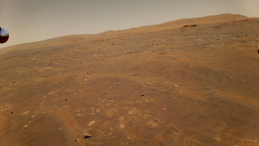 This May 22, 2021 photo made available by NASA shows the surface of Mars from a height of 33 feet (10 meters), captured by the Ingenuity Mars helicopter during its sixth flight. (NASA/JPL-Caltech via AP)