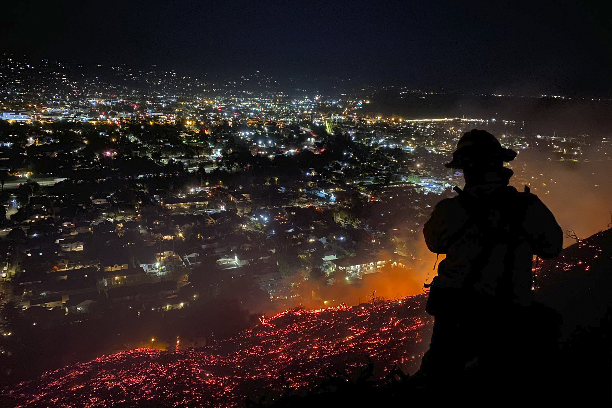 In this photo provided by the Santa Barbara County Fire Department, firefighters battle the Loma Fire in Santa Barbara on May 20, 2021.