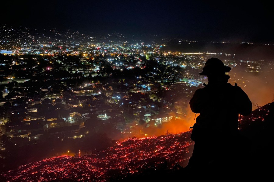 In this photo provided by the Santa Barbara County Fire Department, firefighters battle the Loma Fire in Santa Barbara on May 20, 2021.