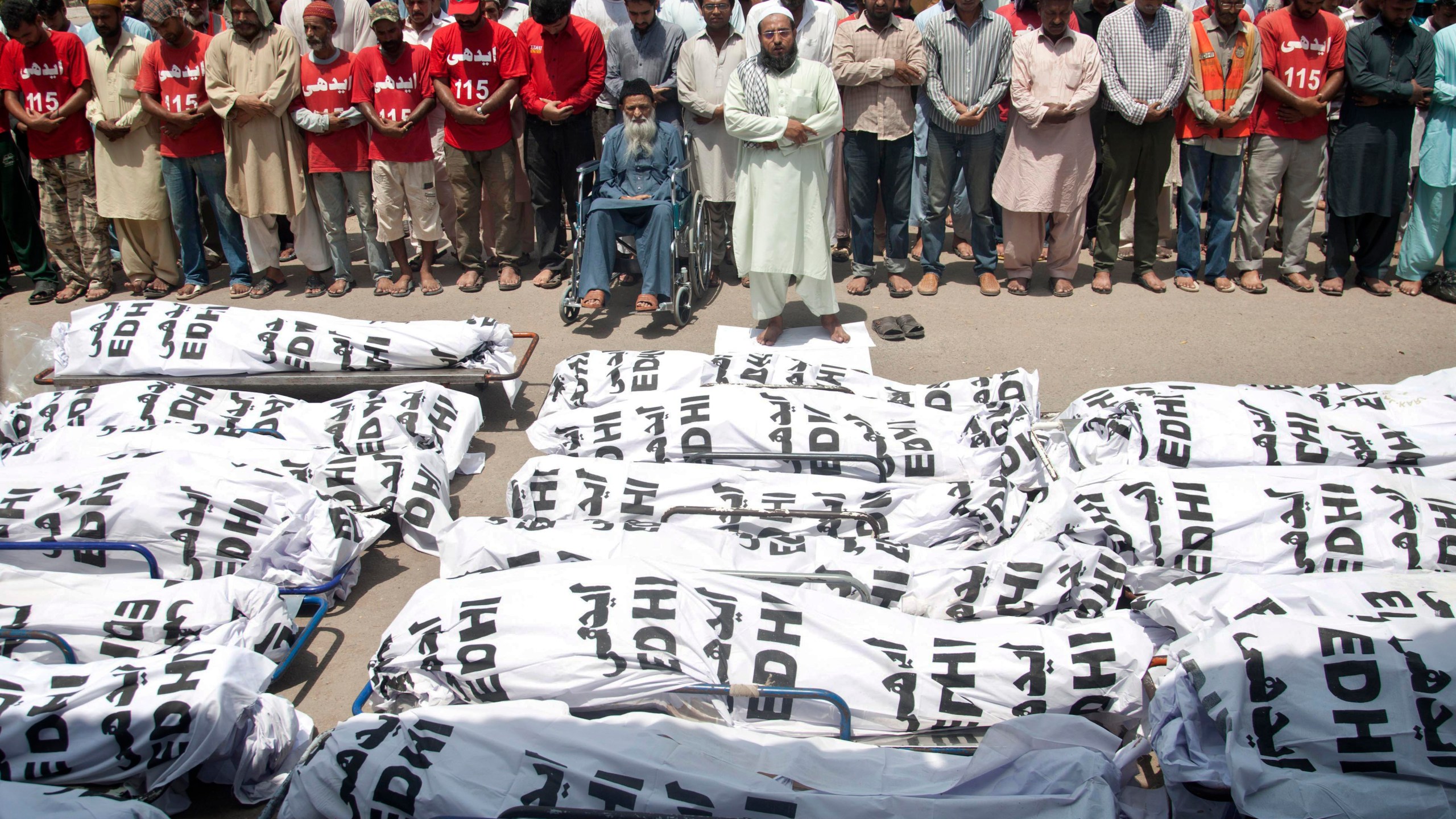 In this June 26, 2015 file photo, mourners attend a funeral for unclaimed people who died of extreme weather in Karachi, Pakistan after a devastating heat wave that struck southern Pakistan the previous weekend, with over 800 confirmed deaths according to a senior health official. A study published in Nature Climate Change on May 31, 2021, has calculated that more than one-third of global heat deaths can directly be attributed to human-caused climate change. (Shakil Adil/Associated Press)